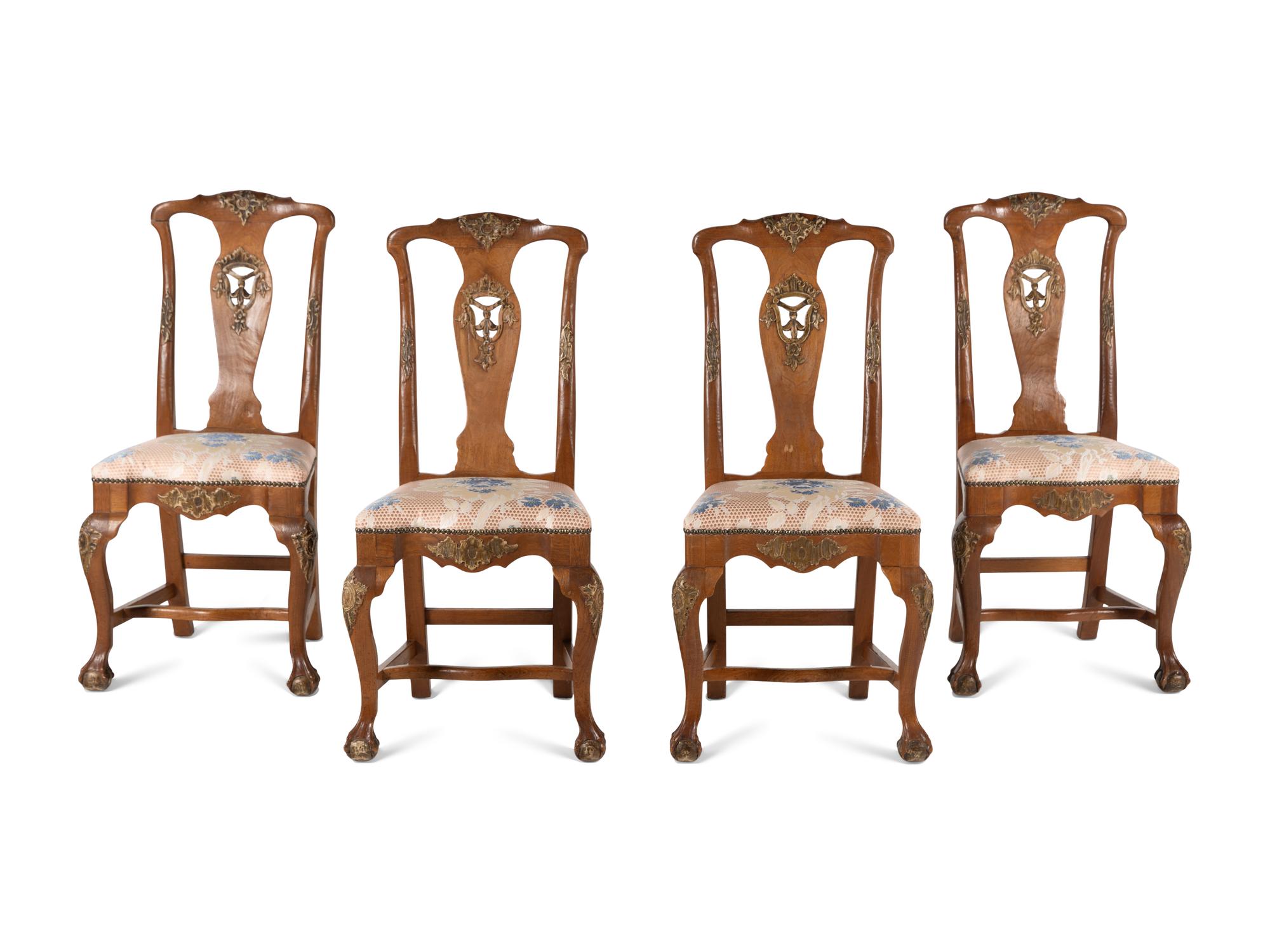 A Set of Four Dutch Parcel-Gilt Walnut Side Chairs