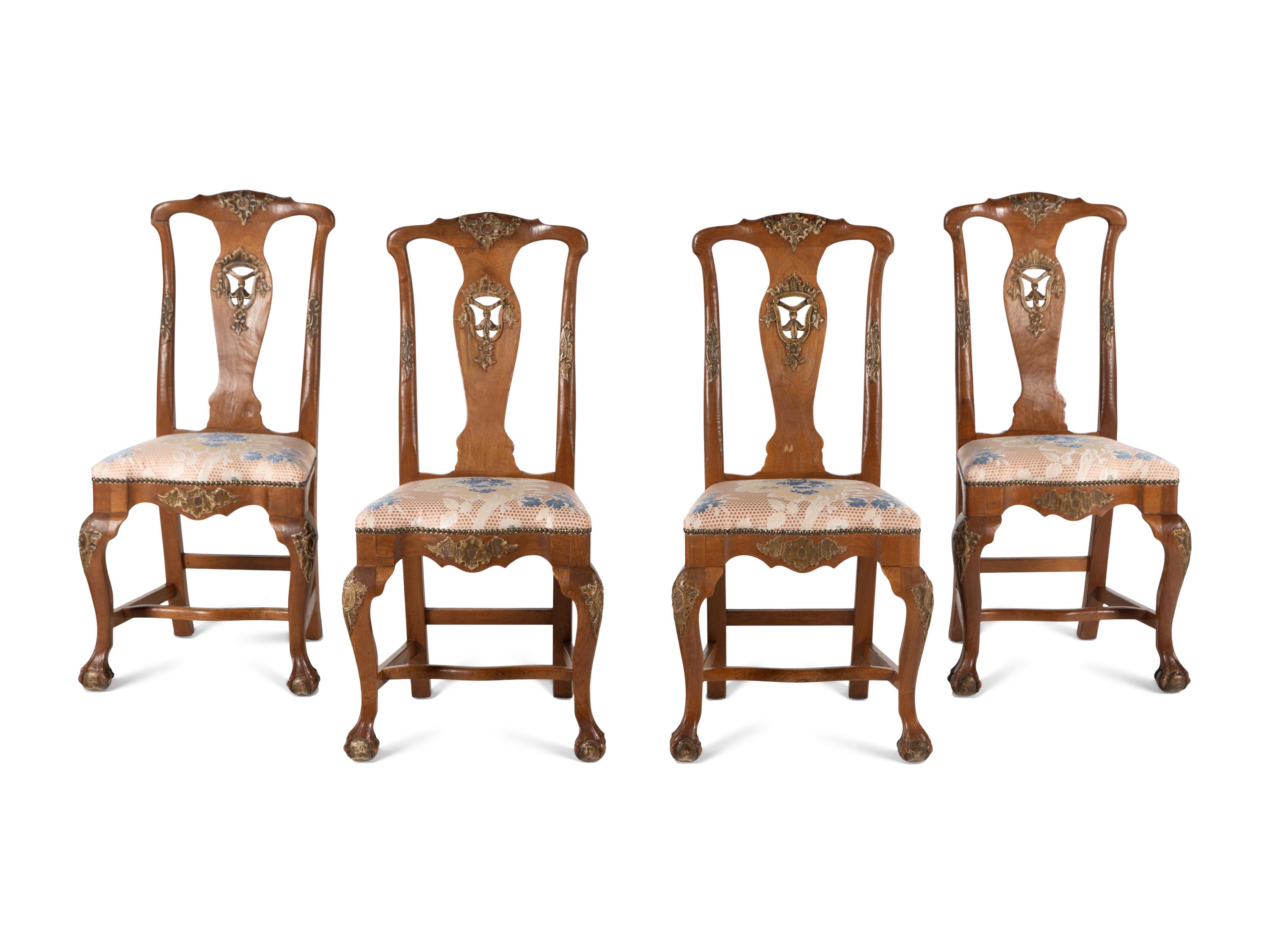 A Set of Four Dutch Parcel-Gilt Walnut Side Chairs