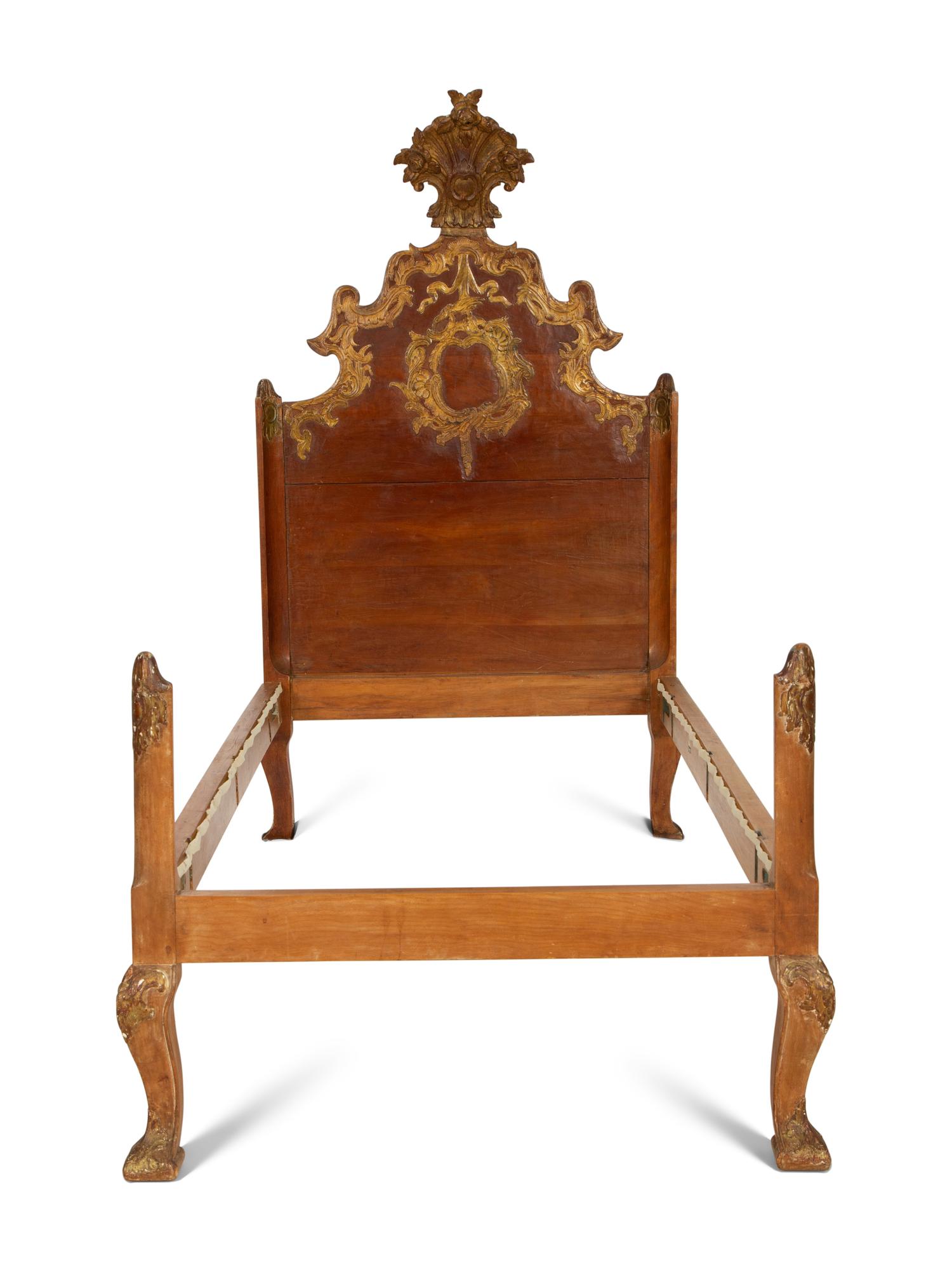 A Pair of Venetian Style Fruitwood and Parcel Gilt Twin Beds