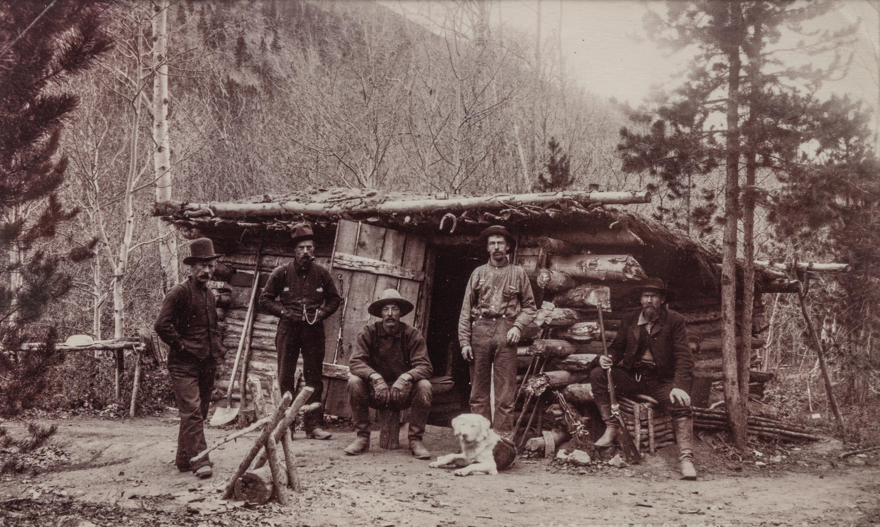 A group of three photographs (3647. Miners at Home; Untitled (main street); 2209. Dug Out - Bluer River Valley)