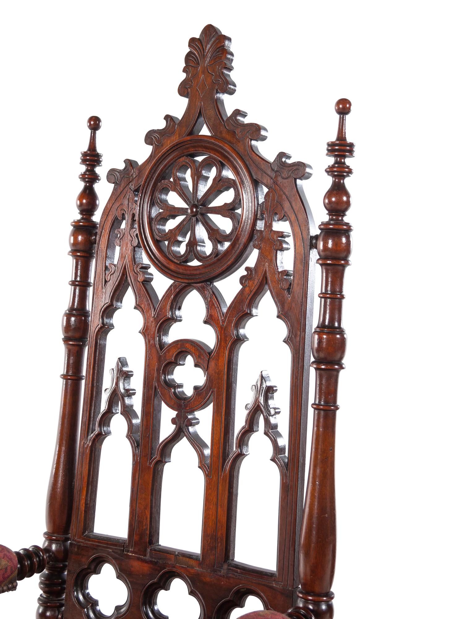 A Pair of Gothic Revival Carved Walnut Armchairs