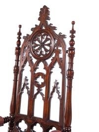 A Pair of Gothic Revival Carved Walnut Armchairs