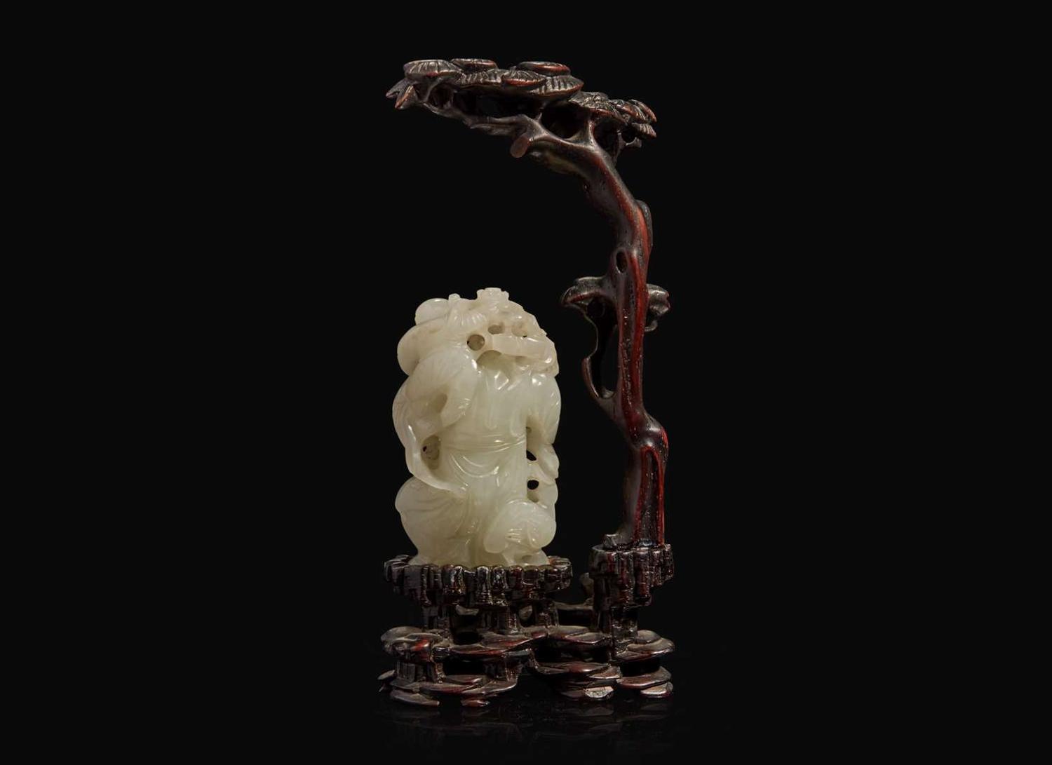 A Chinese white jade figural group with carved hardwood stand 白玉人物與木座