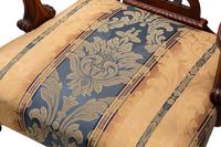 A Set of Sixteen George III Style Carved Walnut Dining Chairs