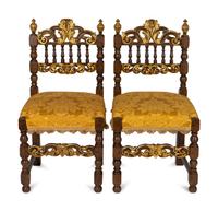 A Pair of Spanish Baroque Style Parcel-Gilt Walnut Slipper Chairs