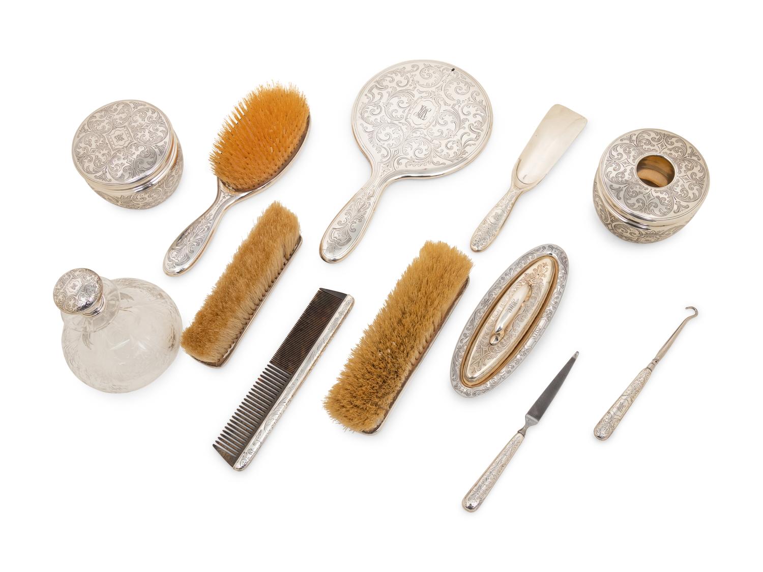 A Tiffany and Co. Silver-Mounted Twelve-Piece Dresser Set