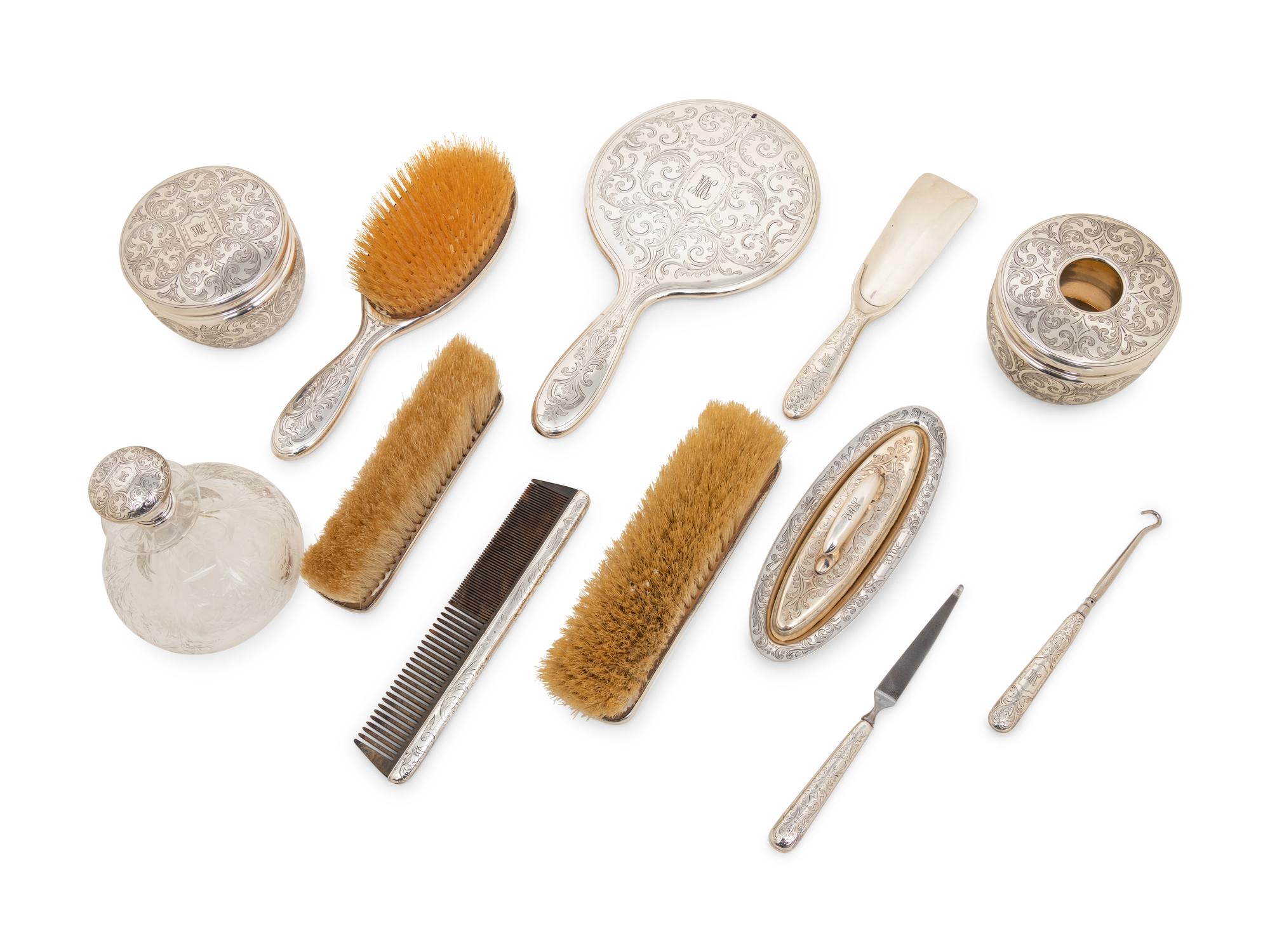 A Tiffany and Co. Silver-Mounted Twelve-Piece Dresser Set