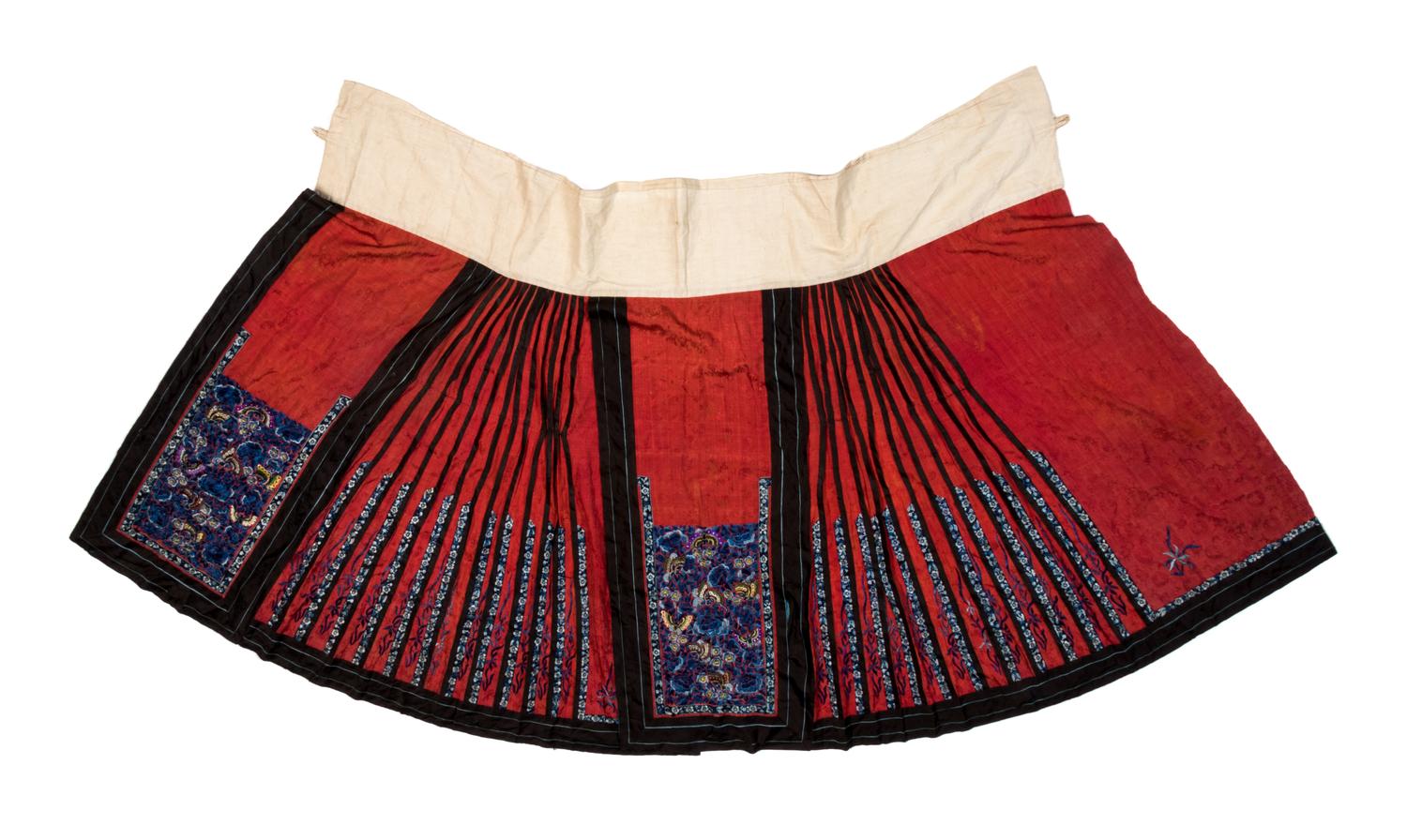 A Chinese Red Ground Embroidered Silk Skirt Length 36 inches. — 19TH CENTURY