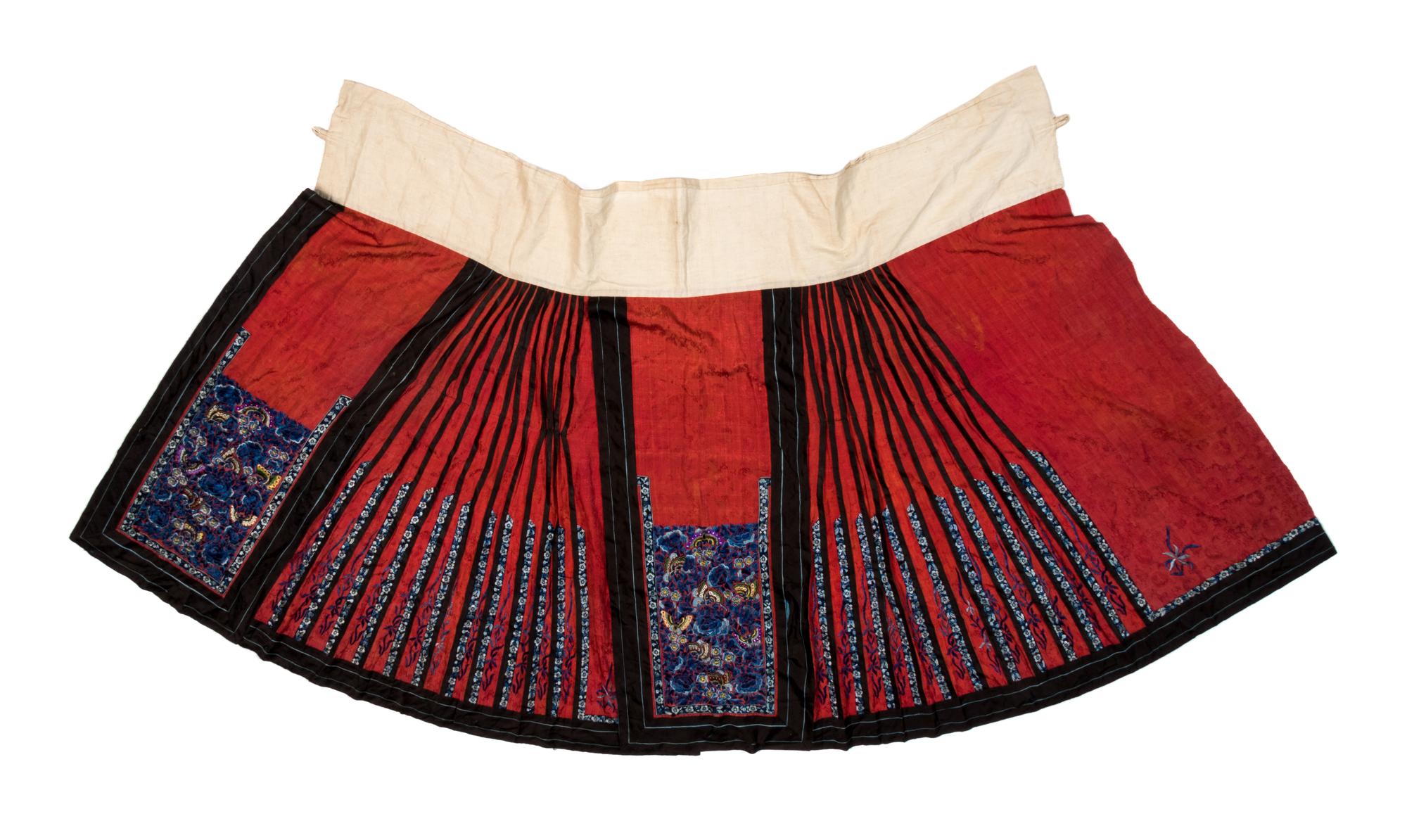 A Chinese Red Ground Embroidered Silk Skirt Length 36 inches. — 19TH CENTURY