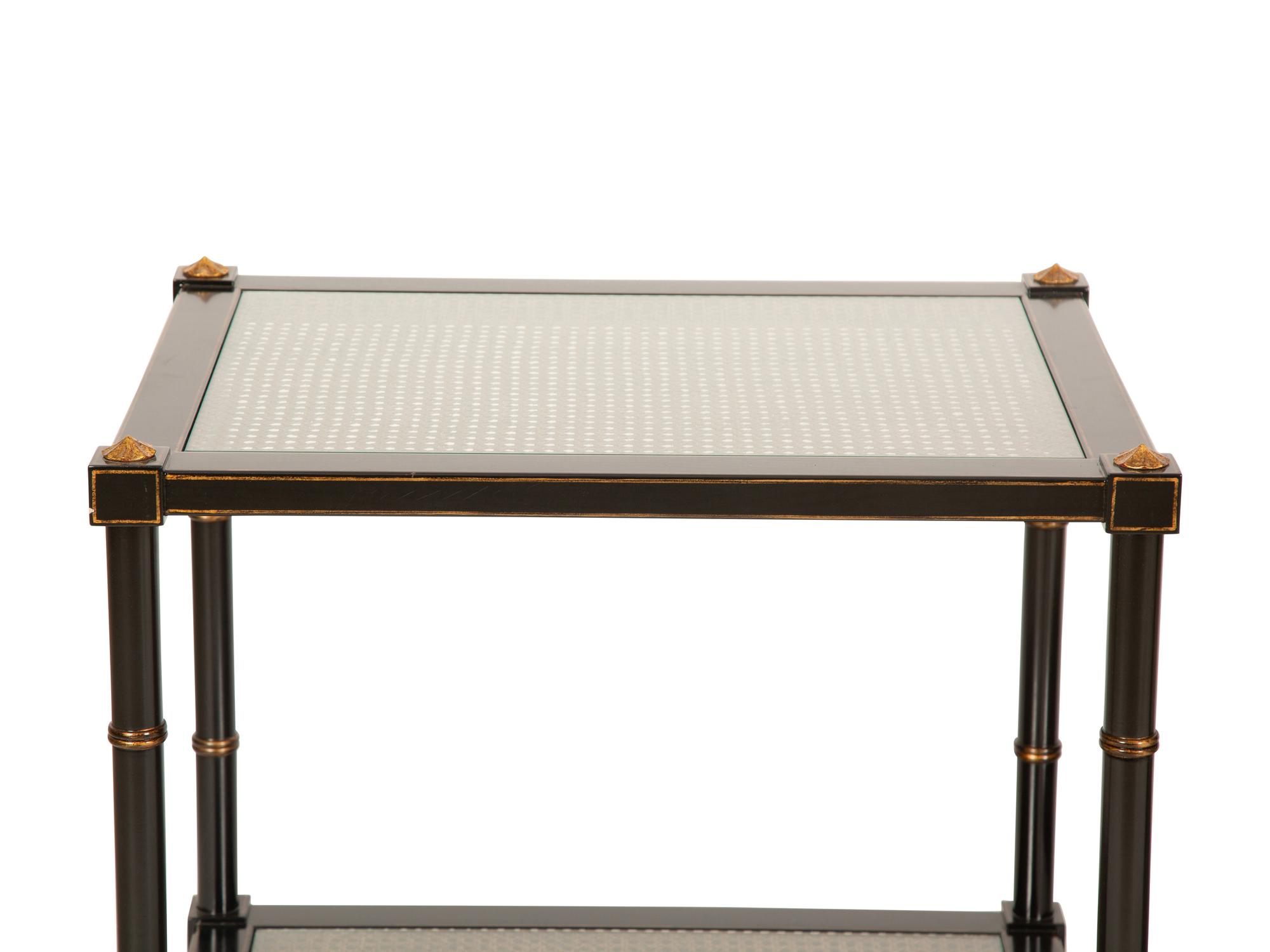 A Pair of Regency Style Ebonized and Gilt Decorated Side Tables