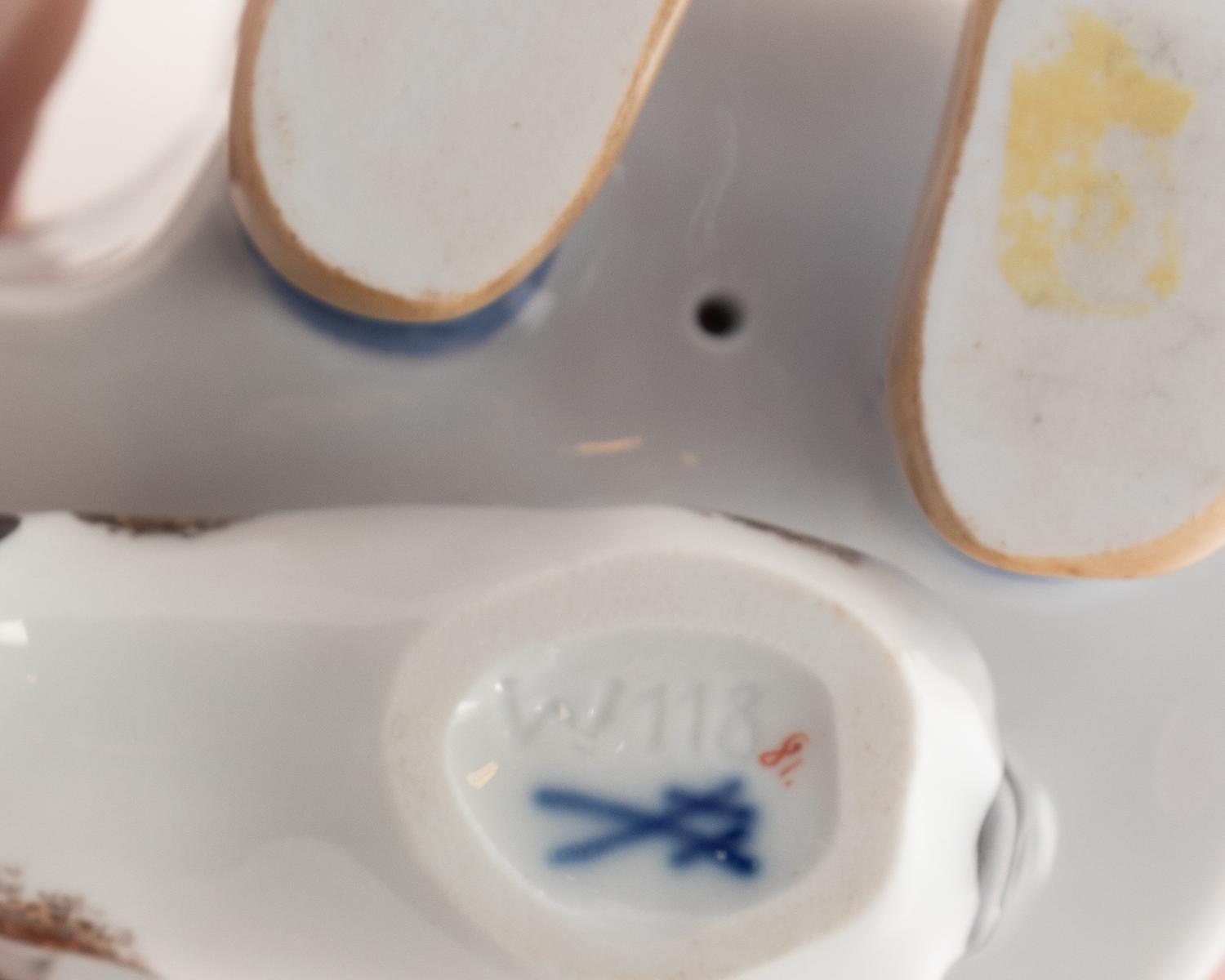 A Meissen Porcelain Figure of a Boy Drinking From a Blue Onion Bowl