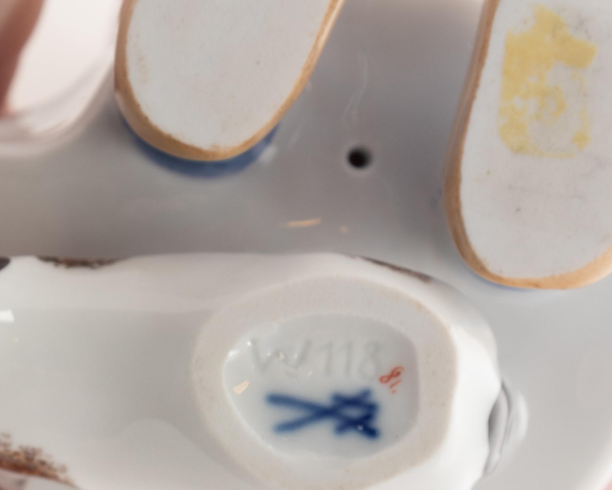 A Meissen Porcelain Figure of a Boy Drinking From a Blue Onion Bowl
