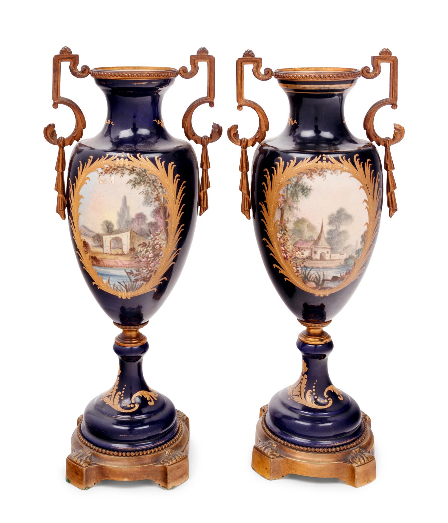 A Pair of Sèvres Style Gilt Bronze Mounted Porcelain Urns