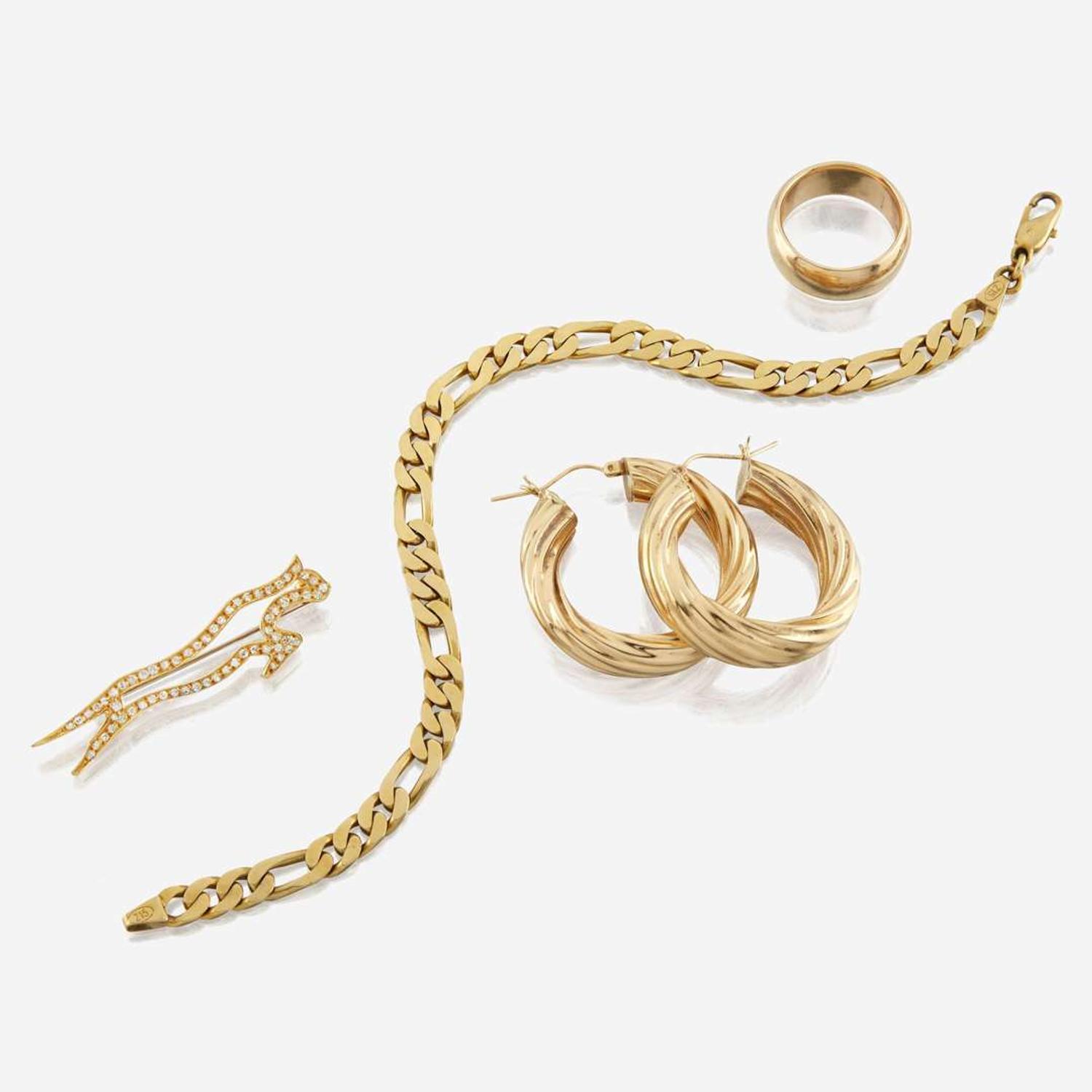 A collection of four pieces of gold jewelry