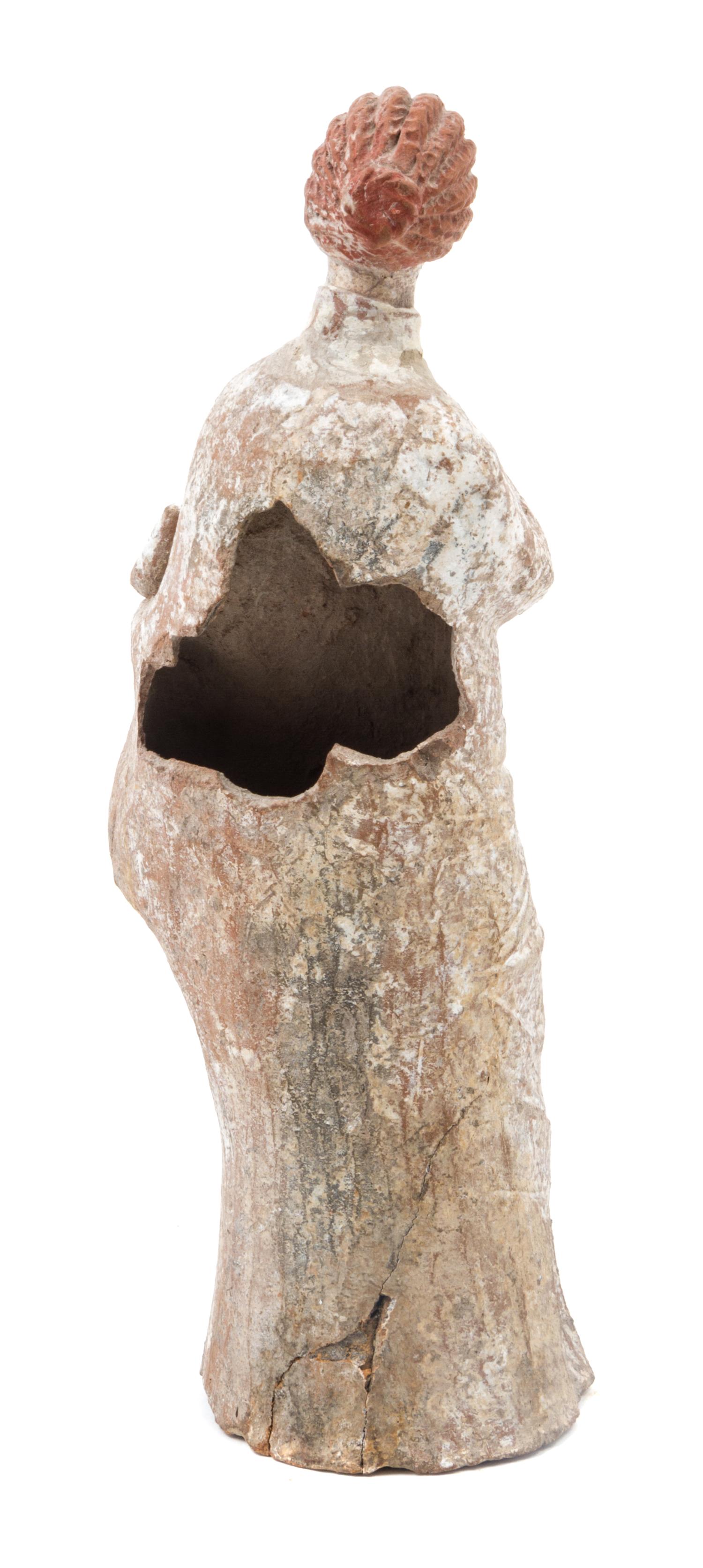 A Hellenistic Terra Cotta Tangara Figure Height 8 1/2 x width 3 1/2 x depth 2 1/2 inches. — ASIA MINOR, CIRCA THIRD CENTURY B.C.