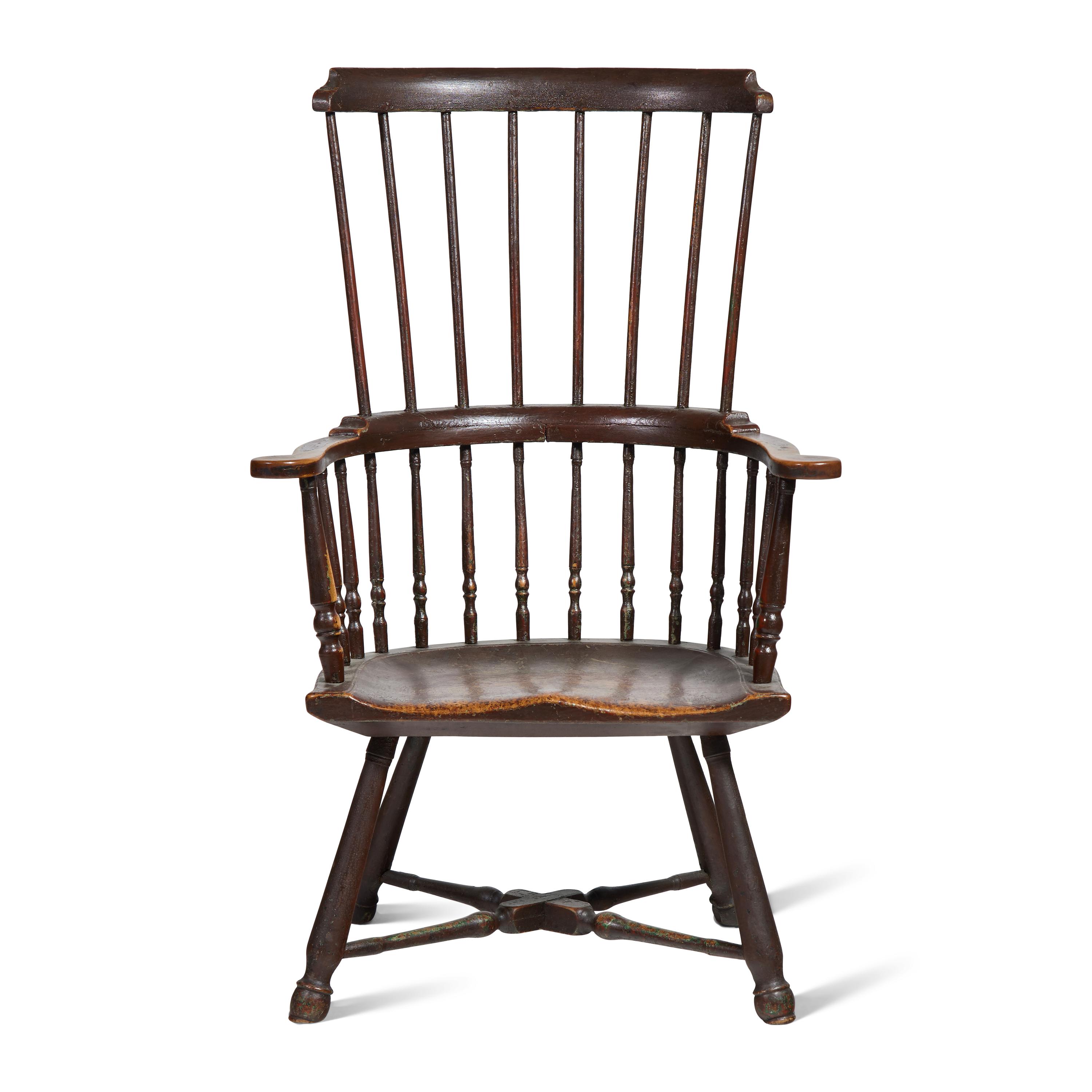 A Turned and Black-Painted Comb-Back Windsor Armchair