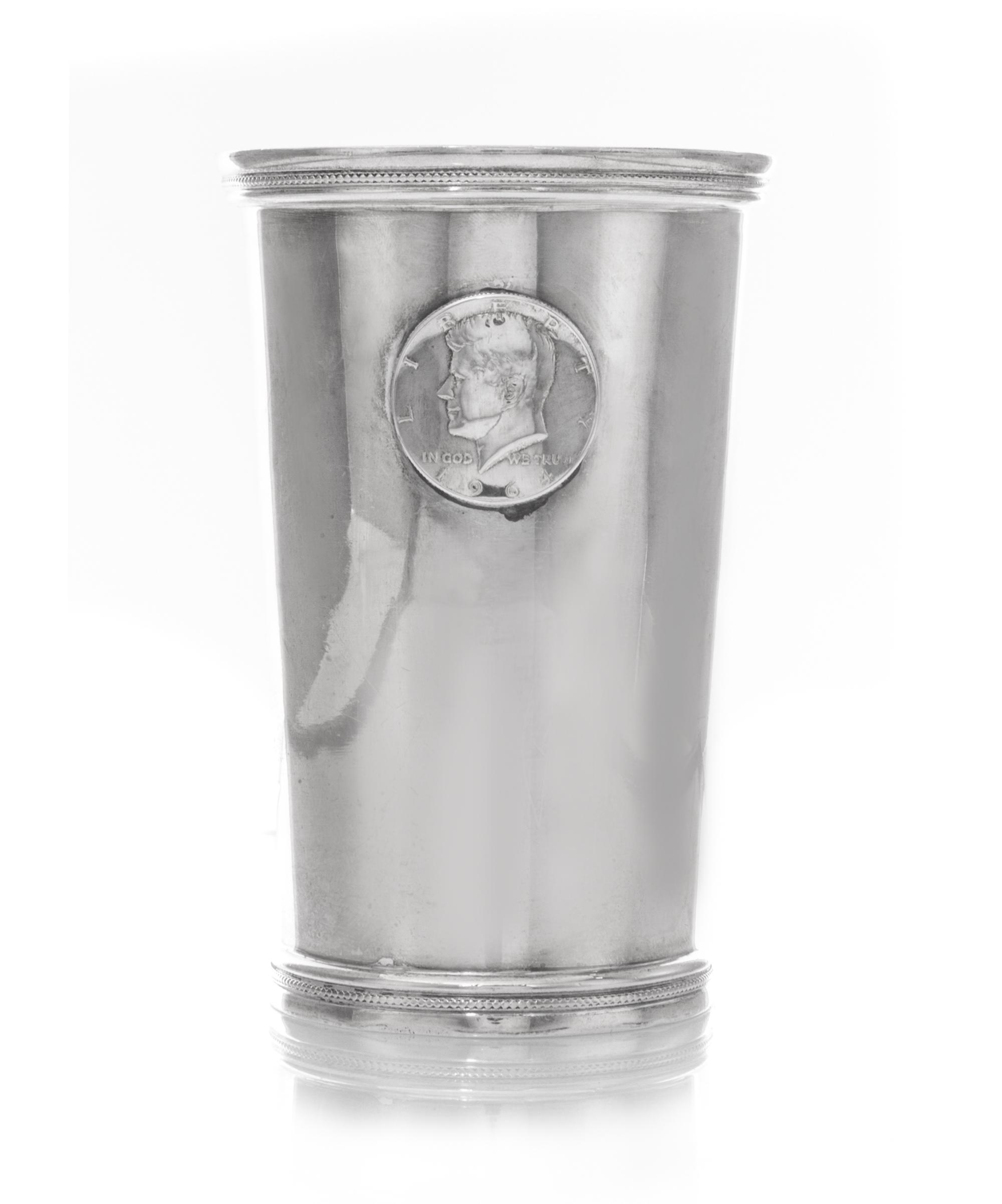 A Mexican Silver Beaker, L.Maciel, 20th Century, tapering, applied with a 1964 American Silver Kennedy Half-Dollar to one side.
