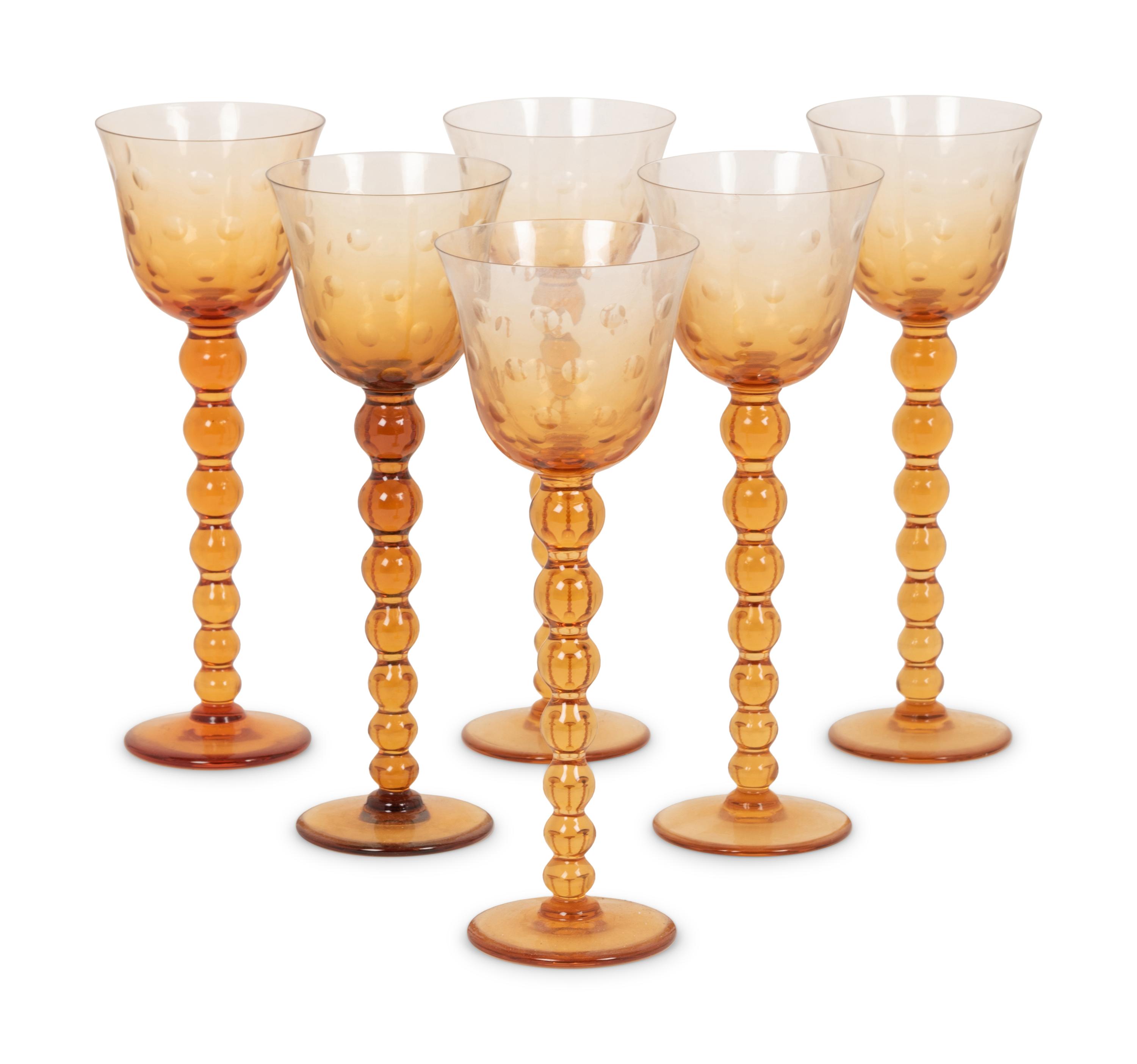A Set of Fifteen St. Louis Amber Glass Stems