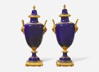 A pair of French gilt bronze mounted cobalt blue porcelain urns, late 19th / early 20th century