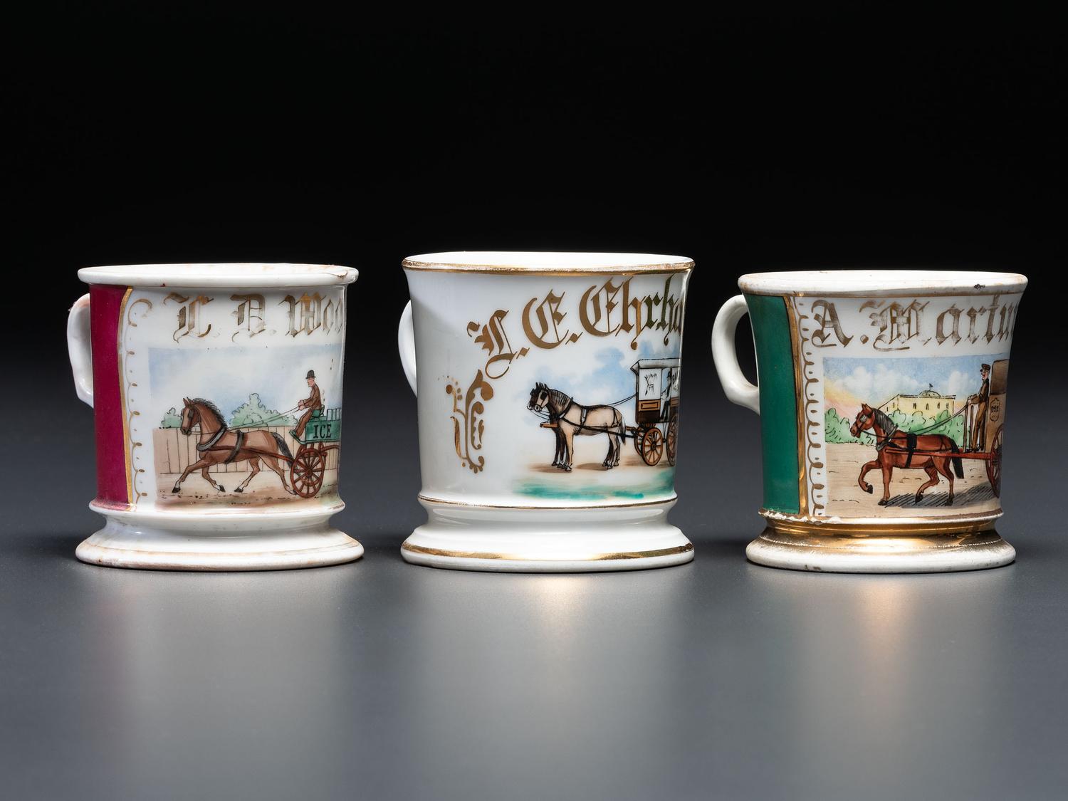 Three Porcelain Occupational Shaving Mugs with Horse-Drawn Carts