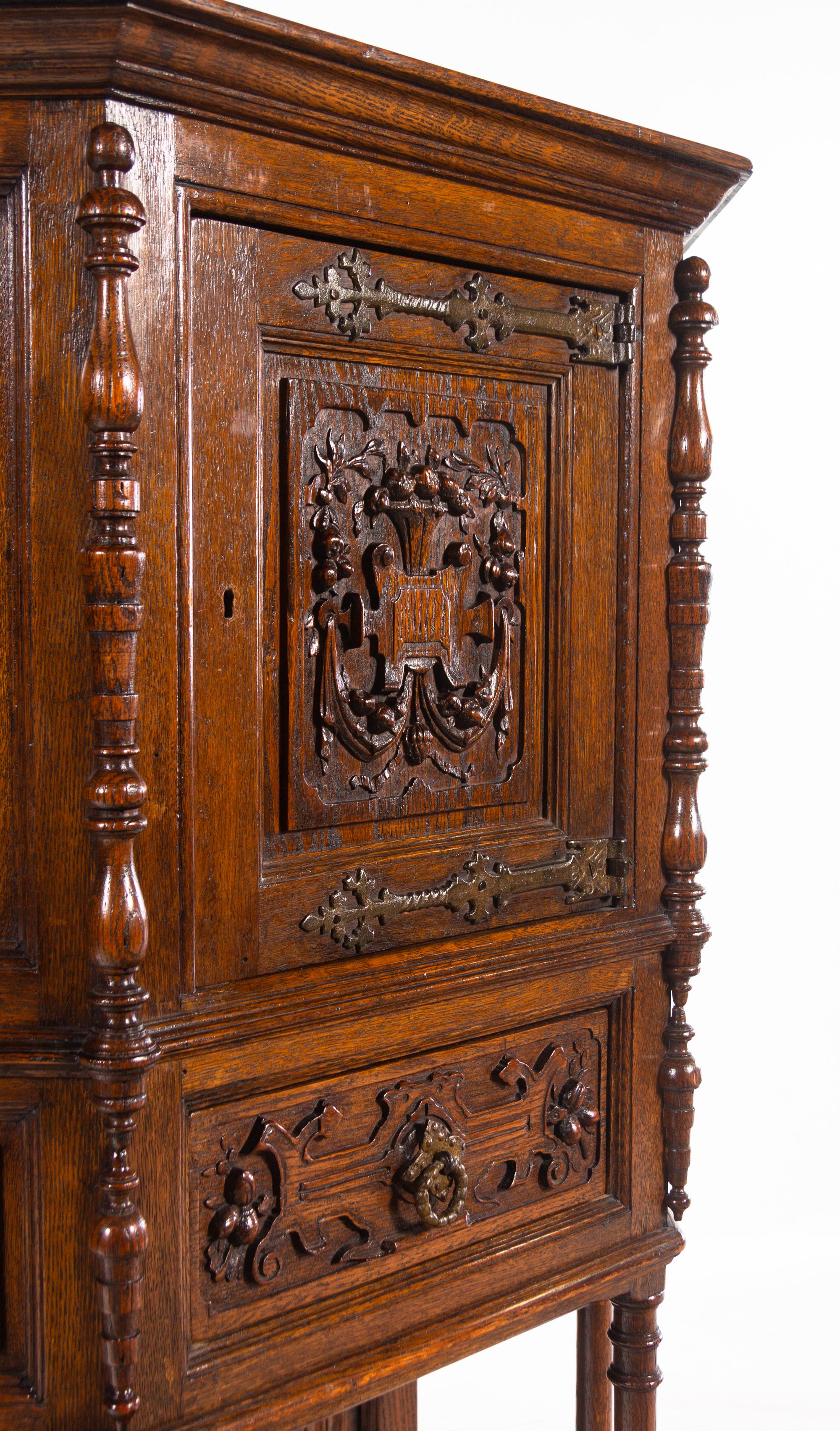 A Gothic Revival Carved Oak Cabinet on Stand