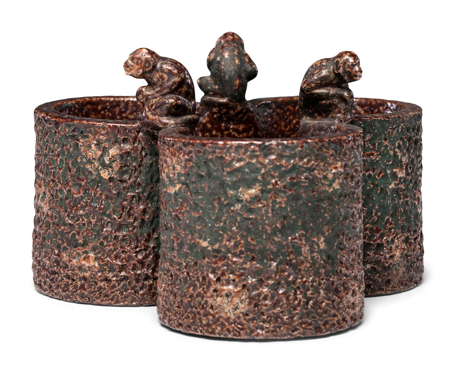 A Glazed Sewer Tile Trefoil Vase or Planter with Seated Monkeys