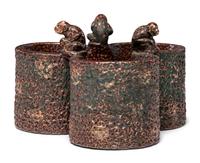 A Glazed Sewer Tile Trefoil Vase or Planter with Seated Monkeys
