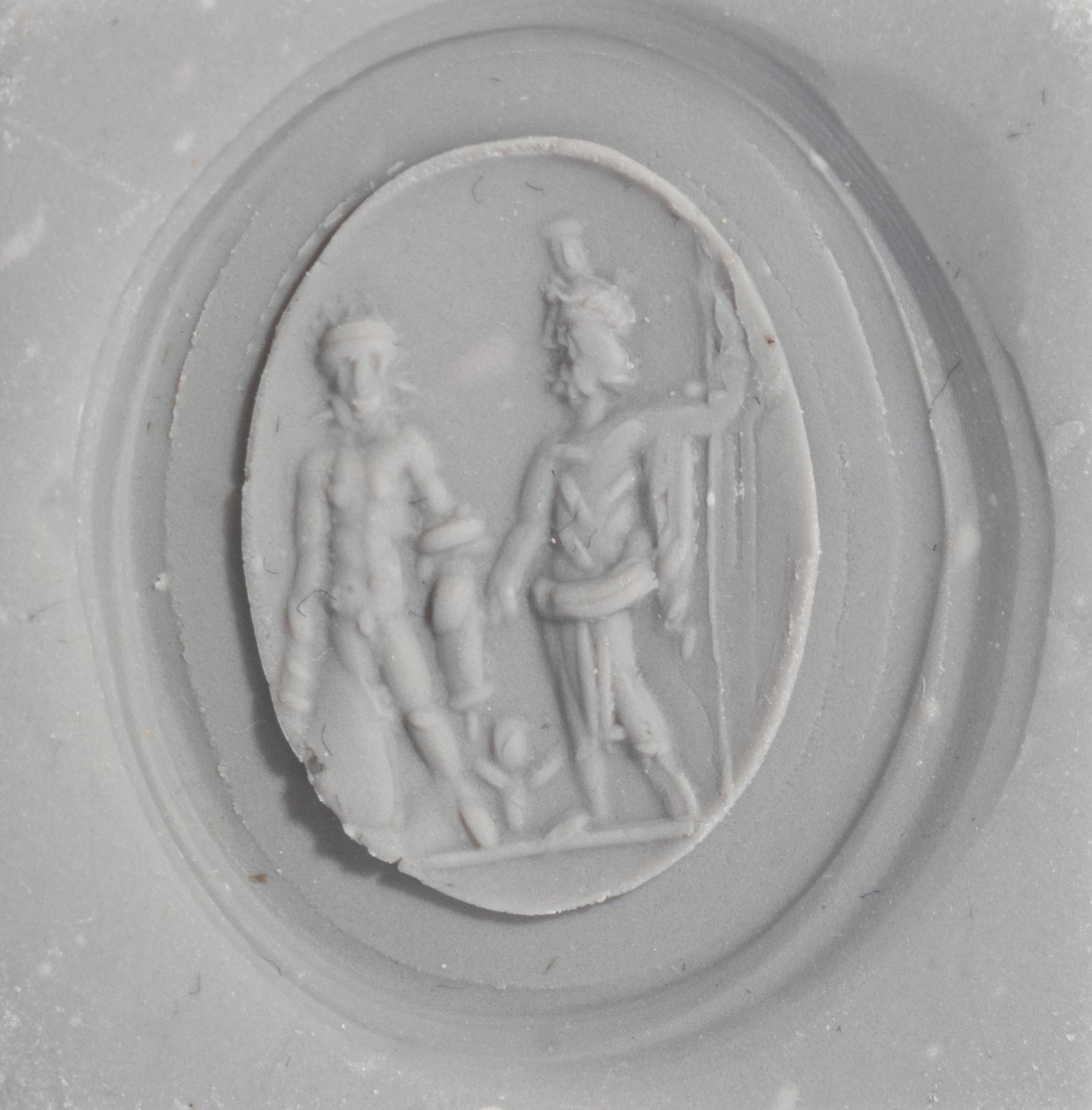 A Roman Carnelian Ring Stone with Two Male Deities and a Child — Set in a gold ring