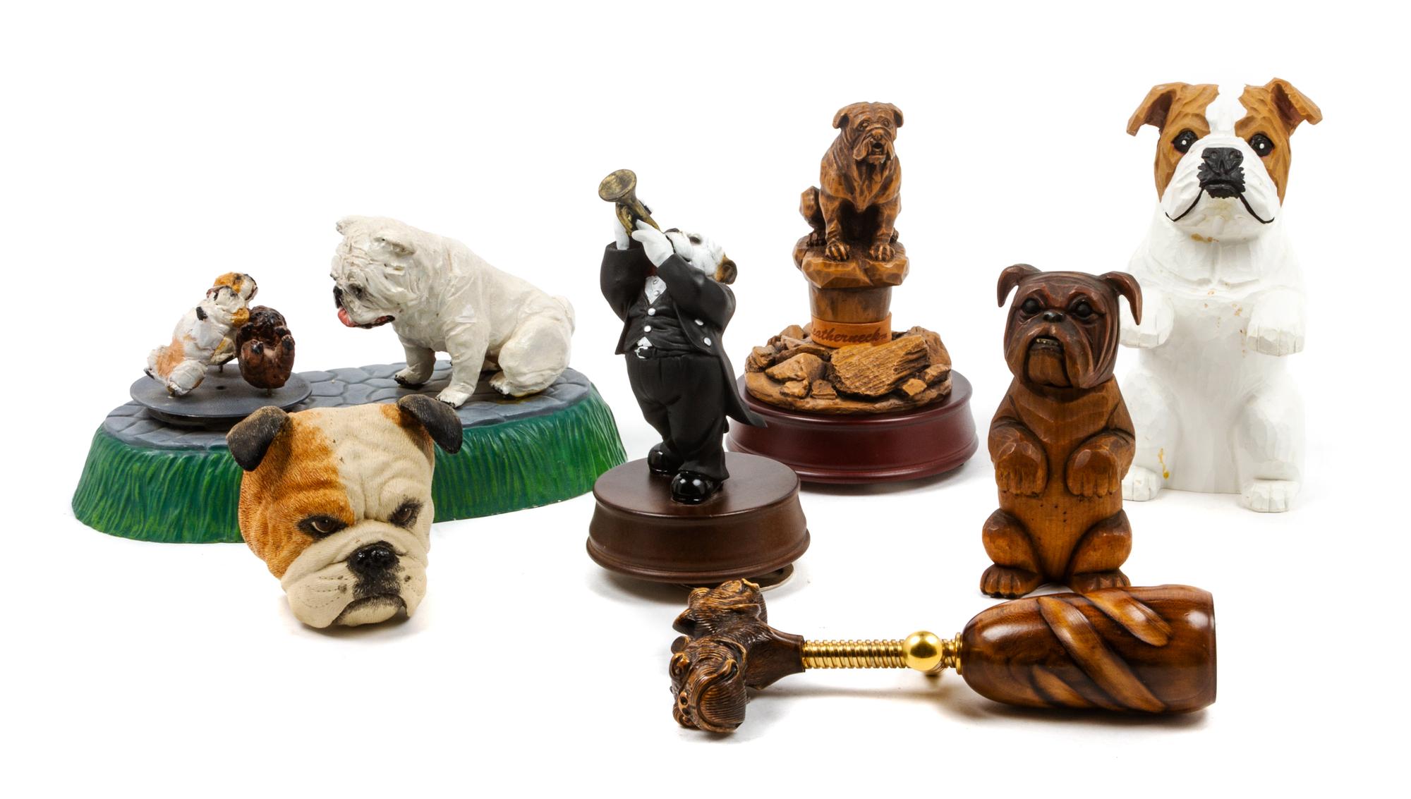 A Group of Seven Bulldog Figures Width of widest 10 inches.