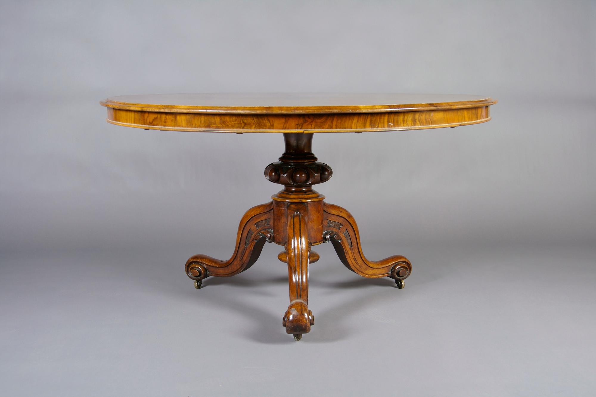 An English Burled Walnut Tilt-Top Table, Height 30 3/4 inches, diameter 50 inches.