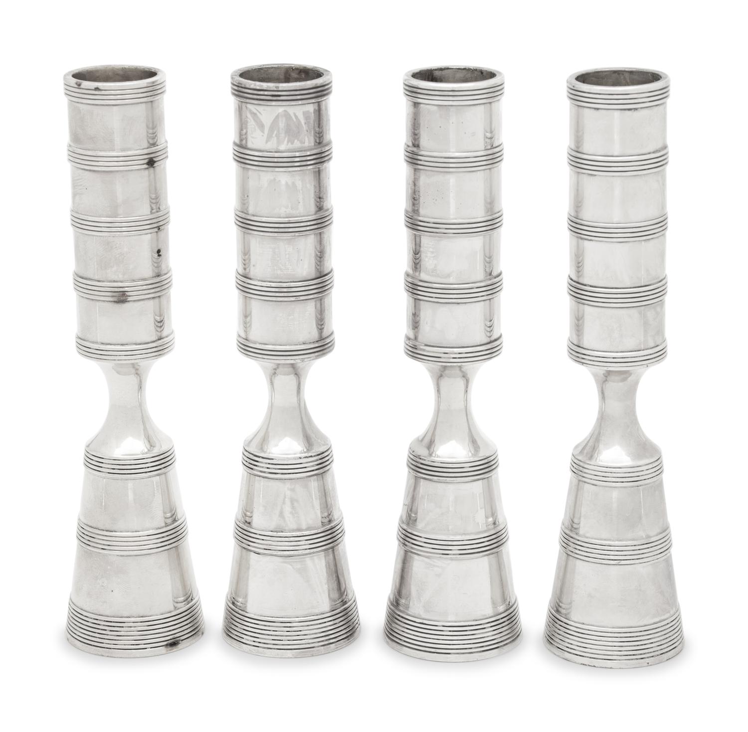 A Set of Four Danish Silvered Metal Candlesticks