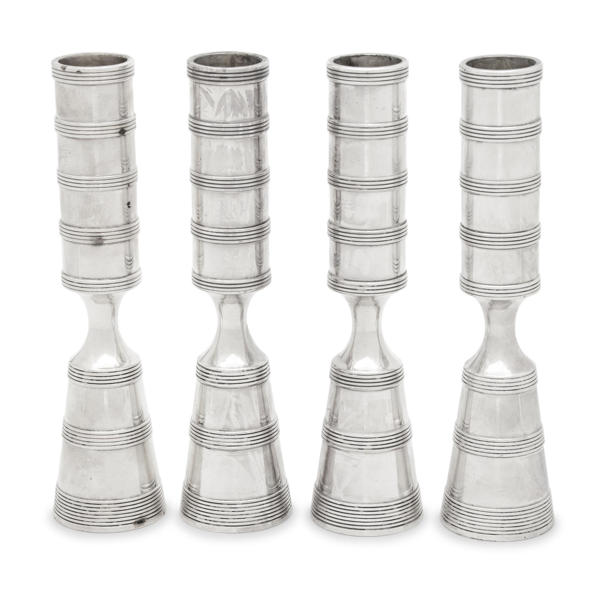 A Set of Four Danish Silvered Metal Candlesticks