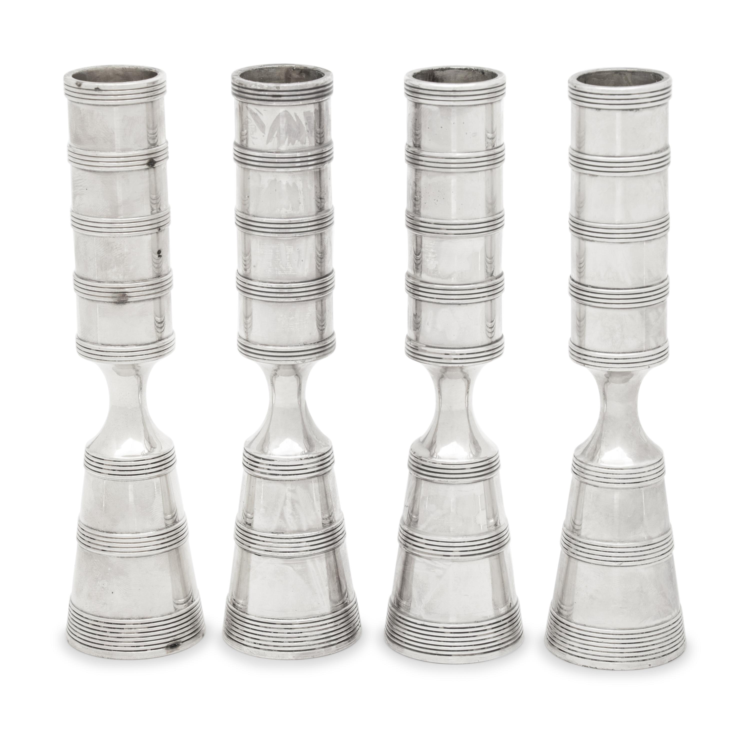 A Set of Four Danish Silvered Metal Candlesticks