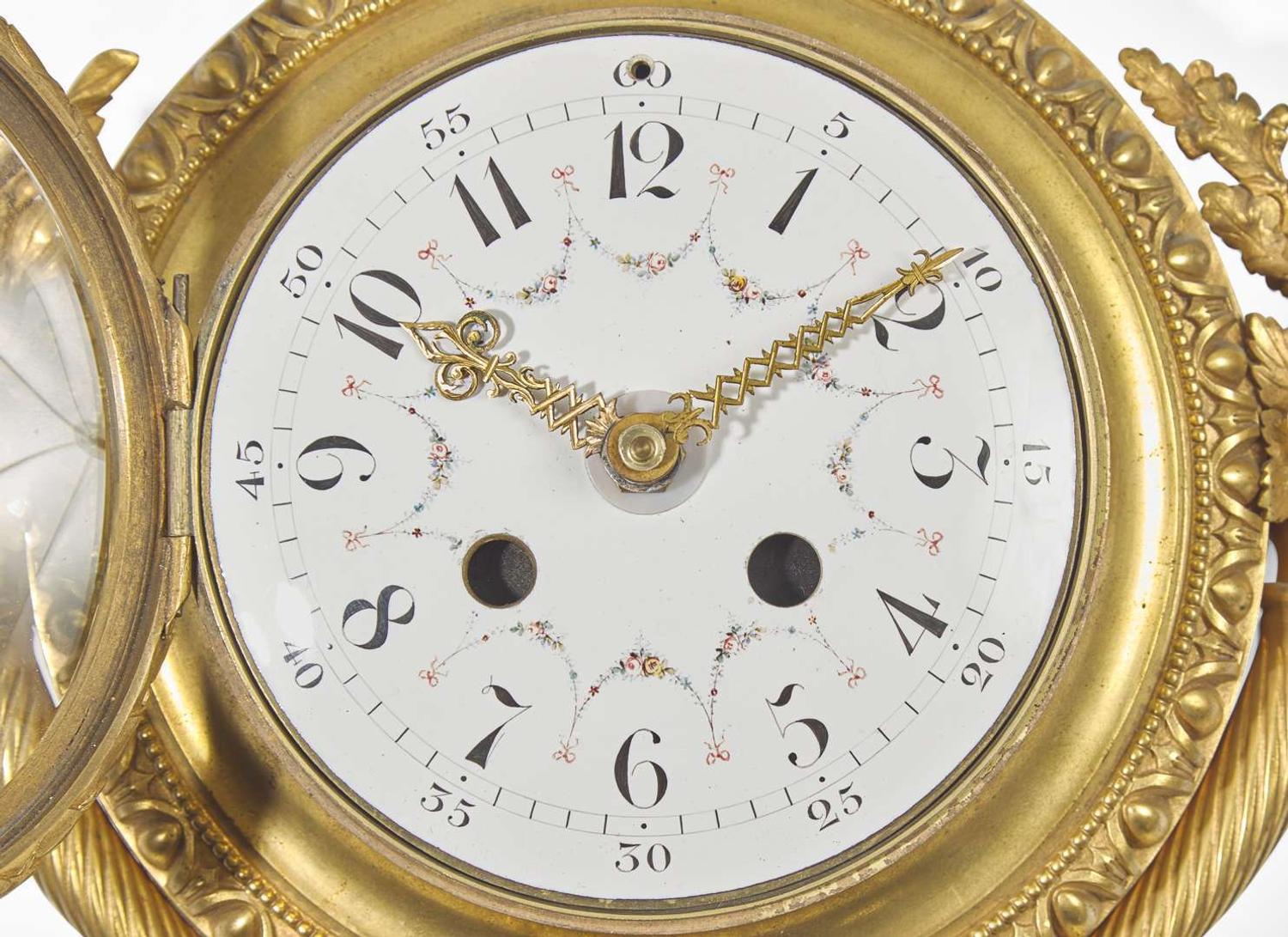 A Louis XVI Style Gilt Bronze and Enameled Porcelain Cartel Clock