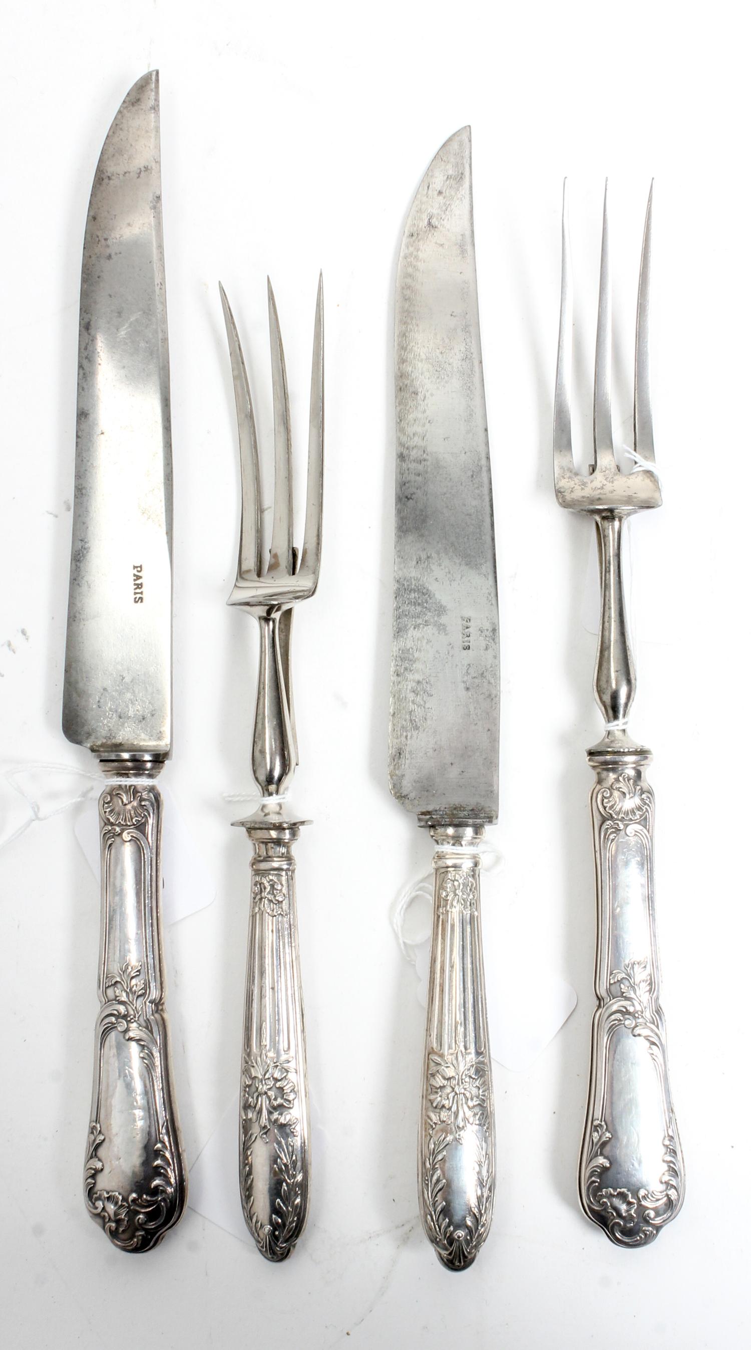 Two French Silver Two-Piece Carving Sets, Late 19th/Early 20th Century, each comprising a carving knife and fork, the silver handles wo