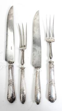 Two French Silver Two-Piece Carving Sets, Late 19th/Early 20th Century, each comprising a carving knife and fork, the silver handles wo