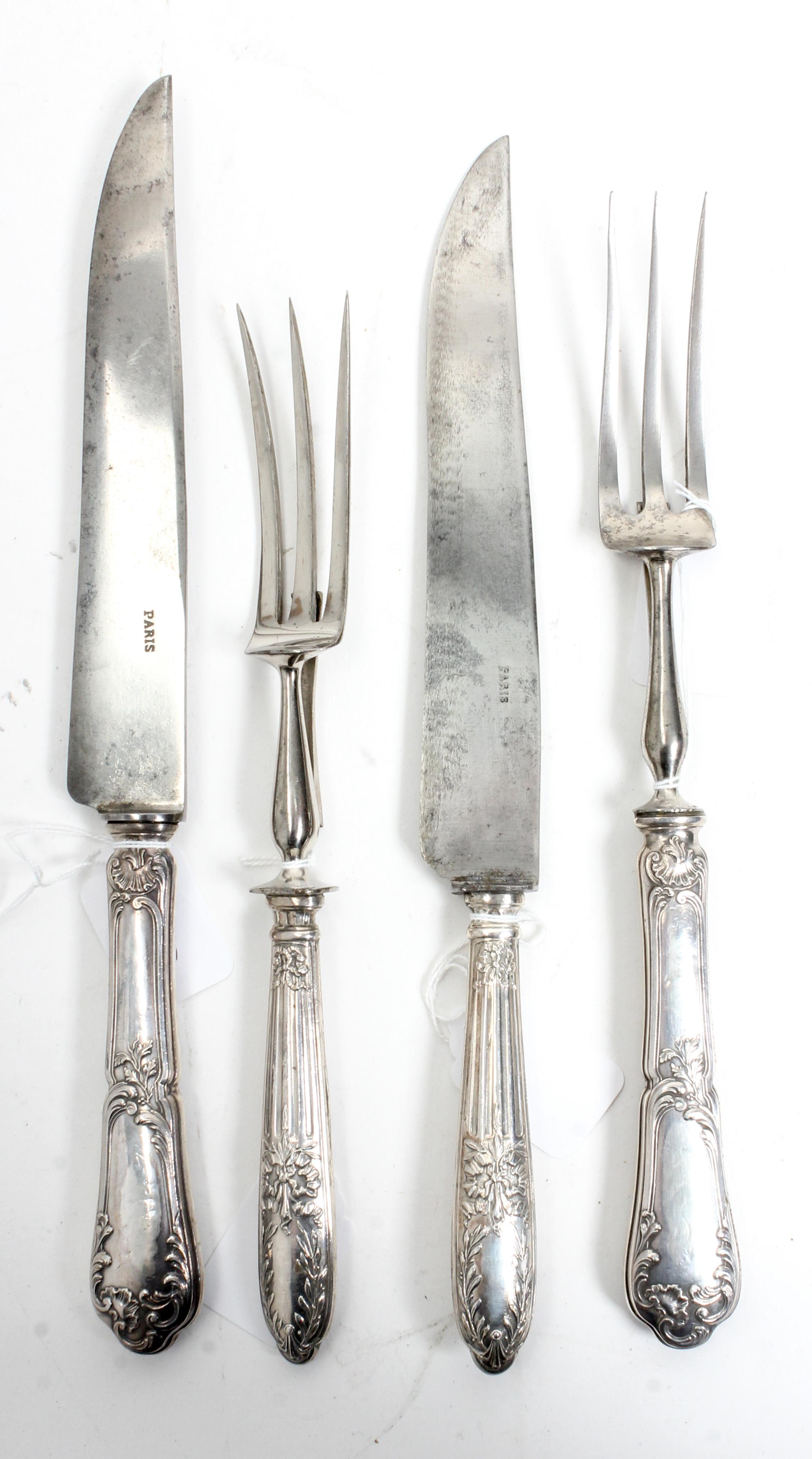Two French Silver Two-Piece Carving Sets, Late 19th/Early 20th Century, each comprising a carving knife and fork, the silver handles wo