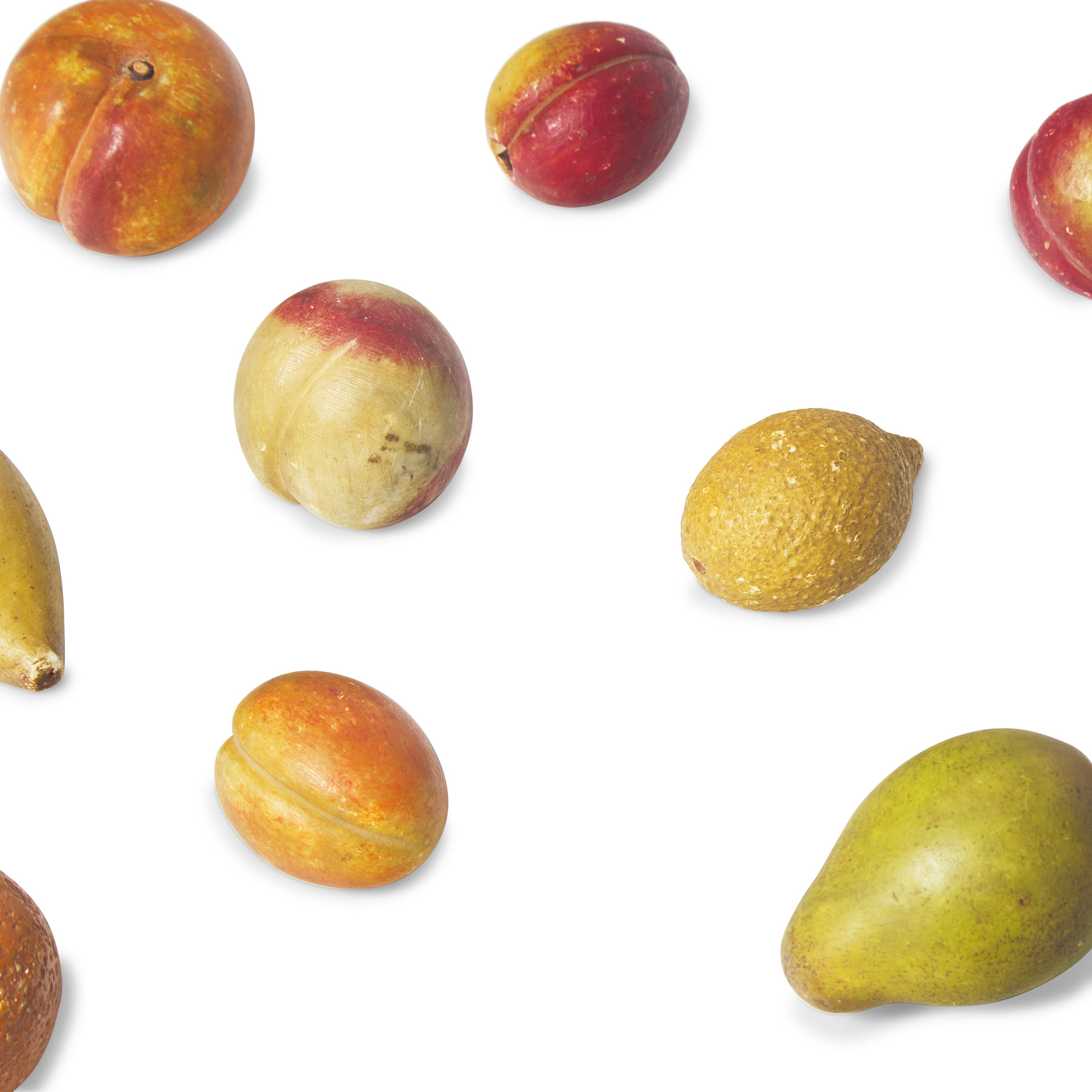 A Group of Sixteen Painted Stone Fruit