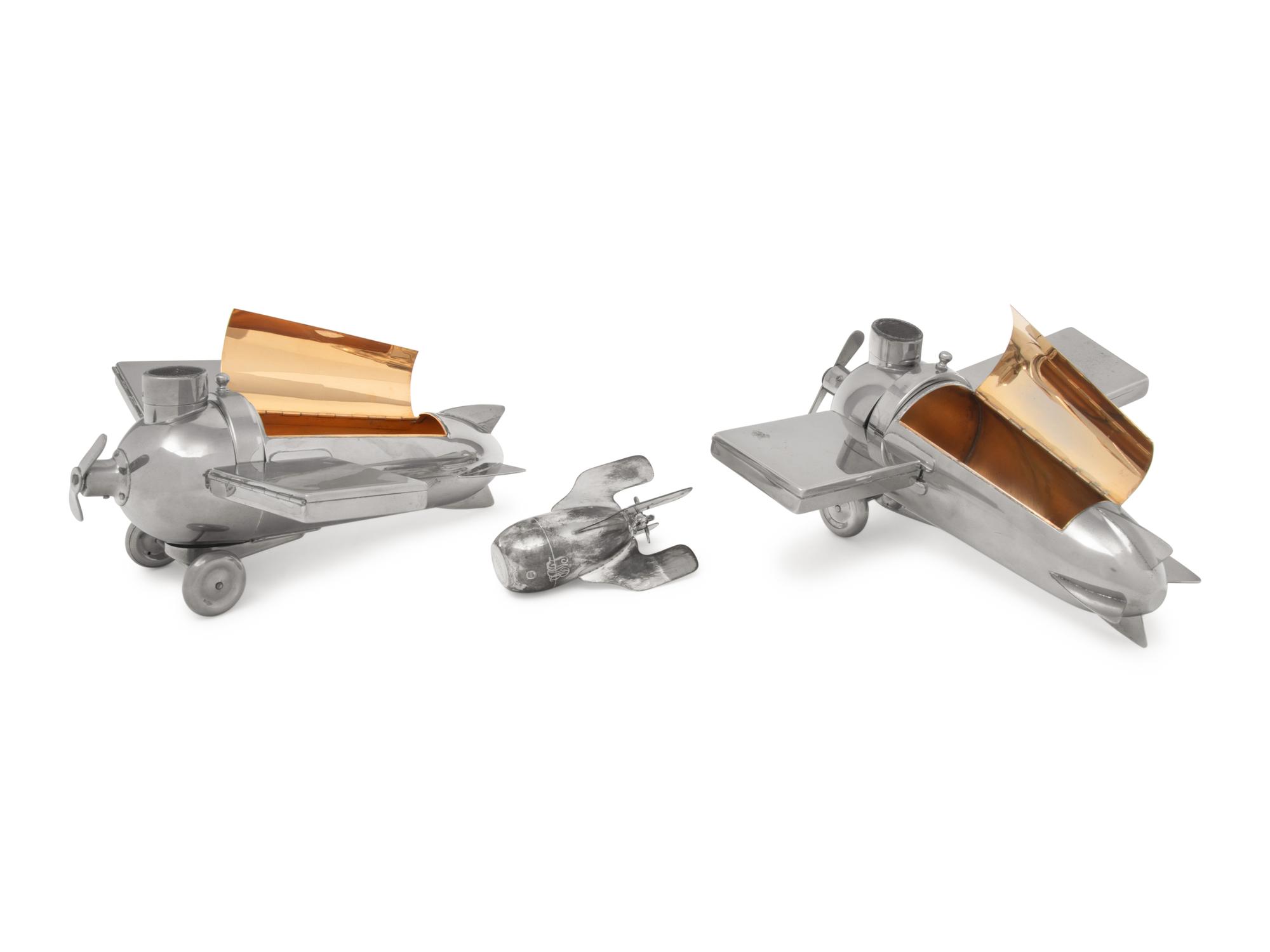 A Pair of German Chromed-Metal Airplane-Form Smoking Sets
