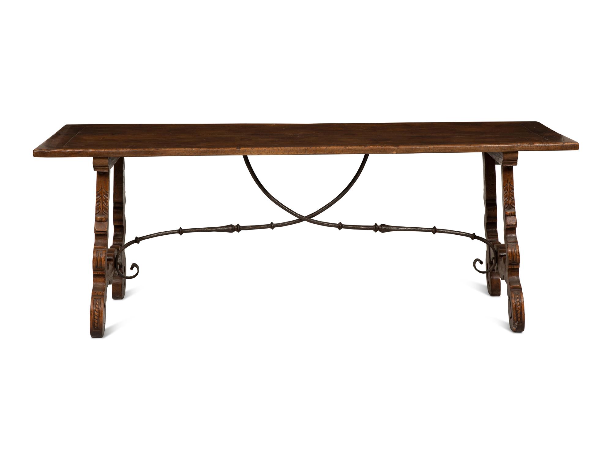 A Spanish Walnut and Wrought Iron Trestle Table