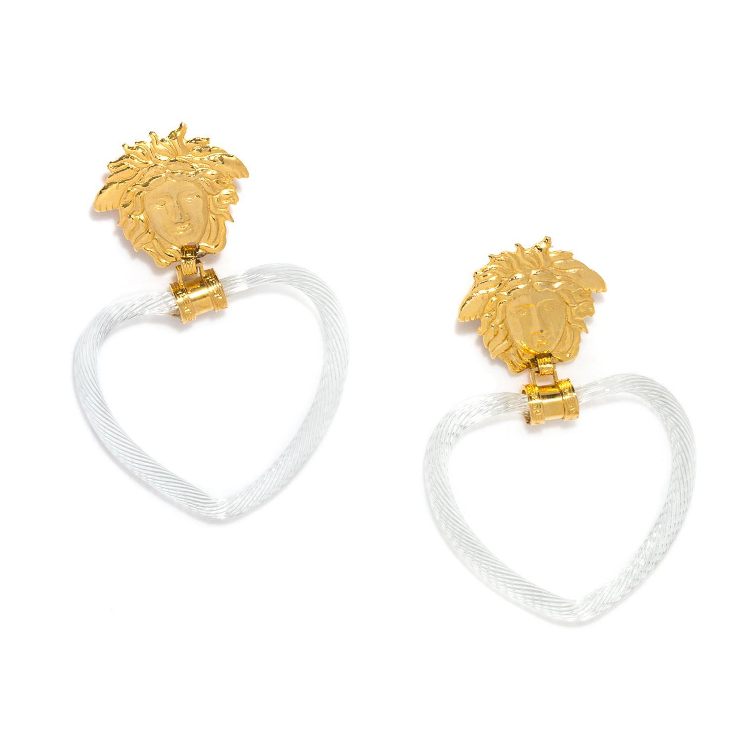 A Pair of Gianni Versace Medusa and Glass Heart Drop Earclips, Medusa: 1.75" x 1.75"; Drop: 4.75".