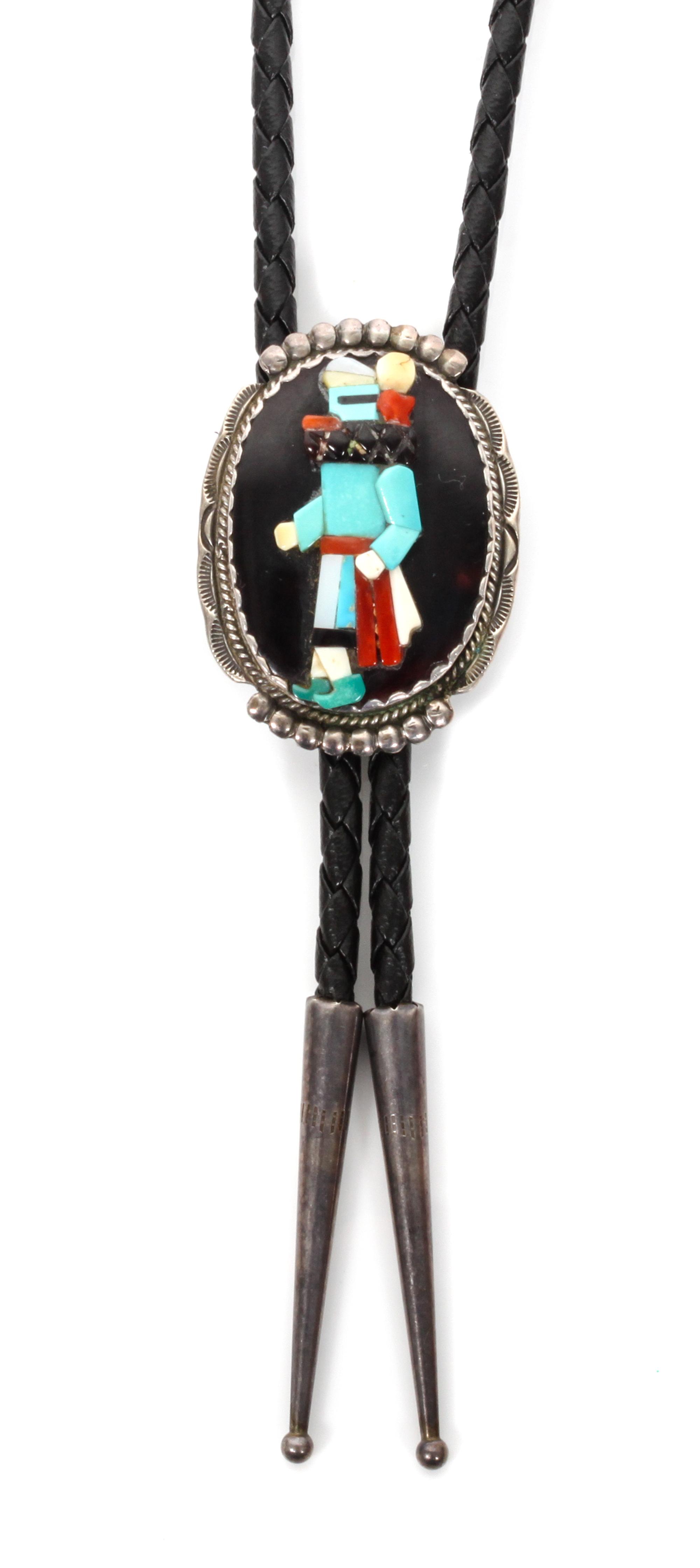 A Zuni Silver and Multiple Stone Bolo, Beverly Etsate Height 1 5/8 x width 1 1/4 inches.