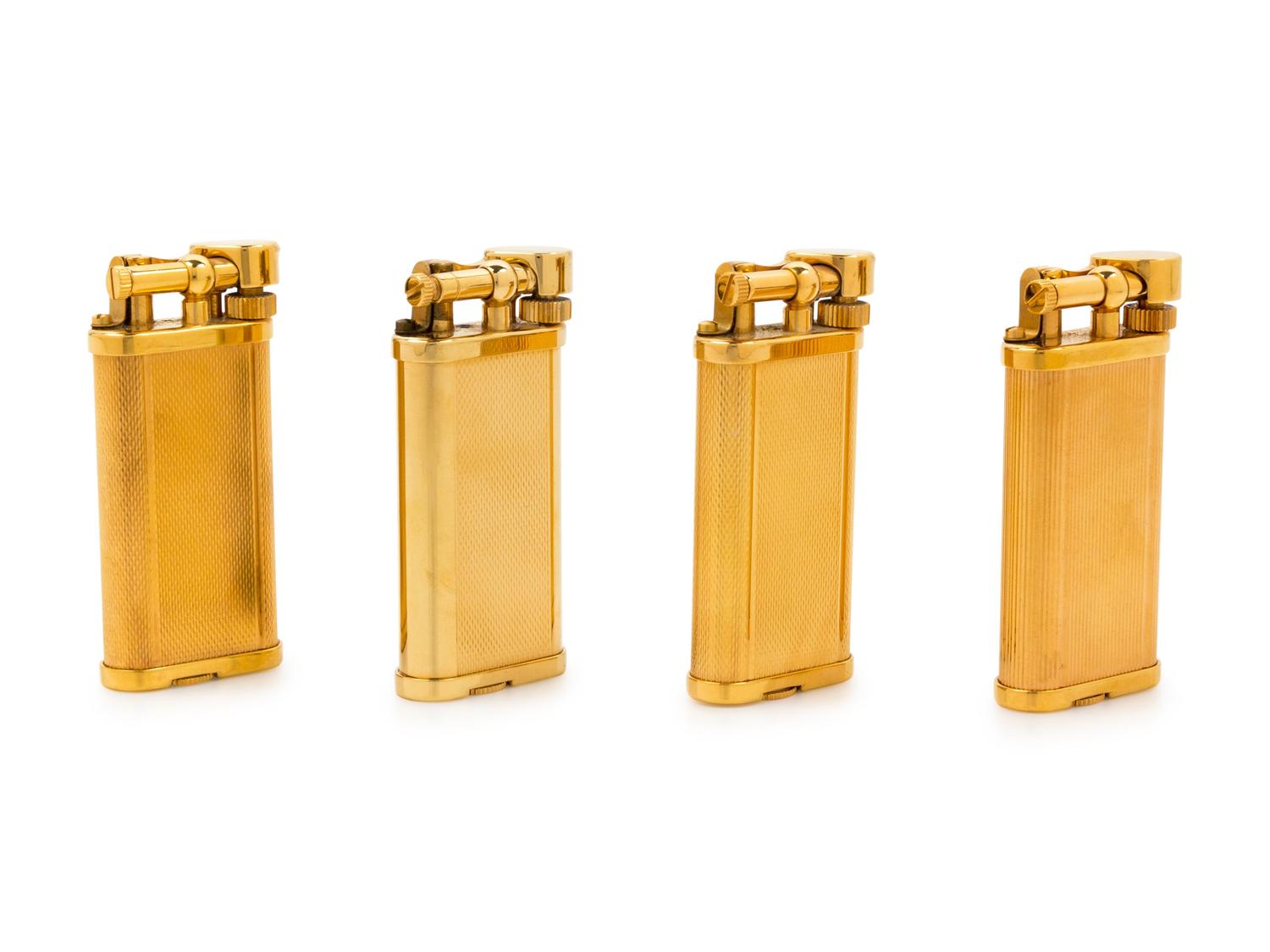 A Group of Four Gilt Metal Dunhill Lift-Arm Lighters