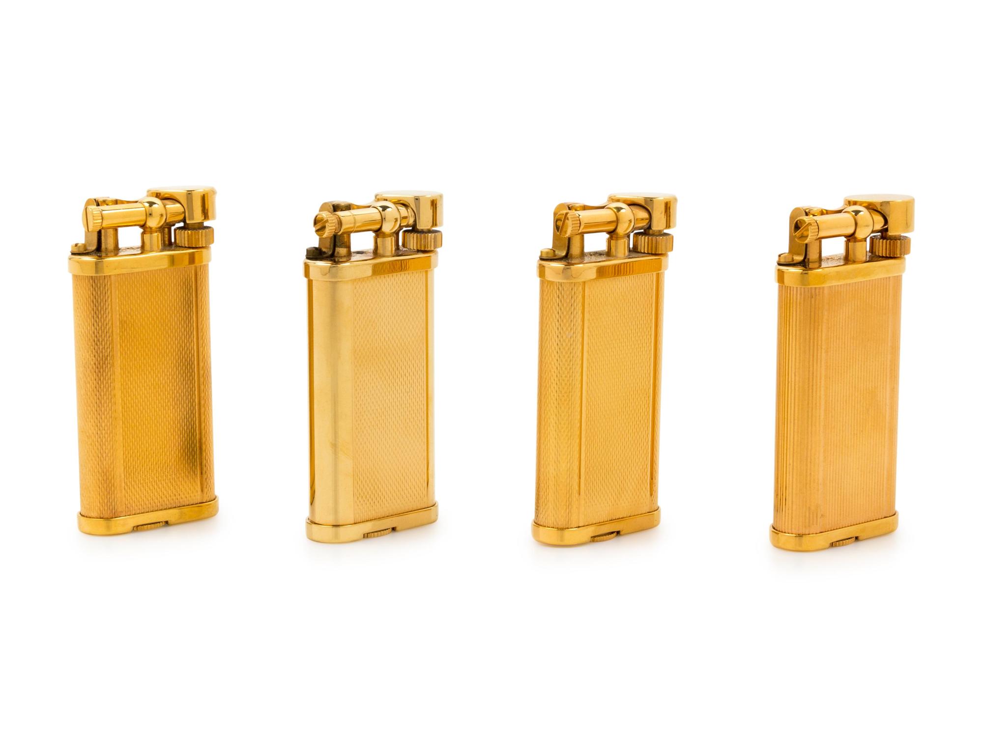 A Group of Four Gilt Metal Dunhill Lift-Arm Lighters