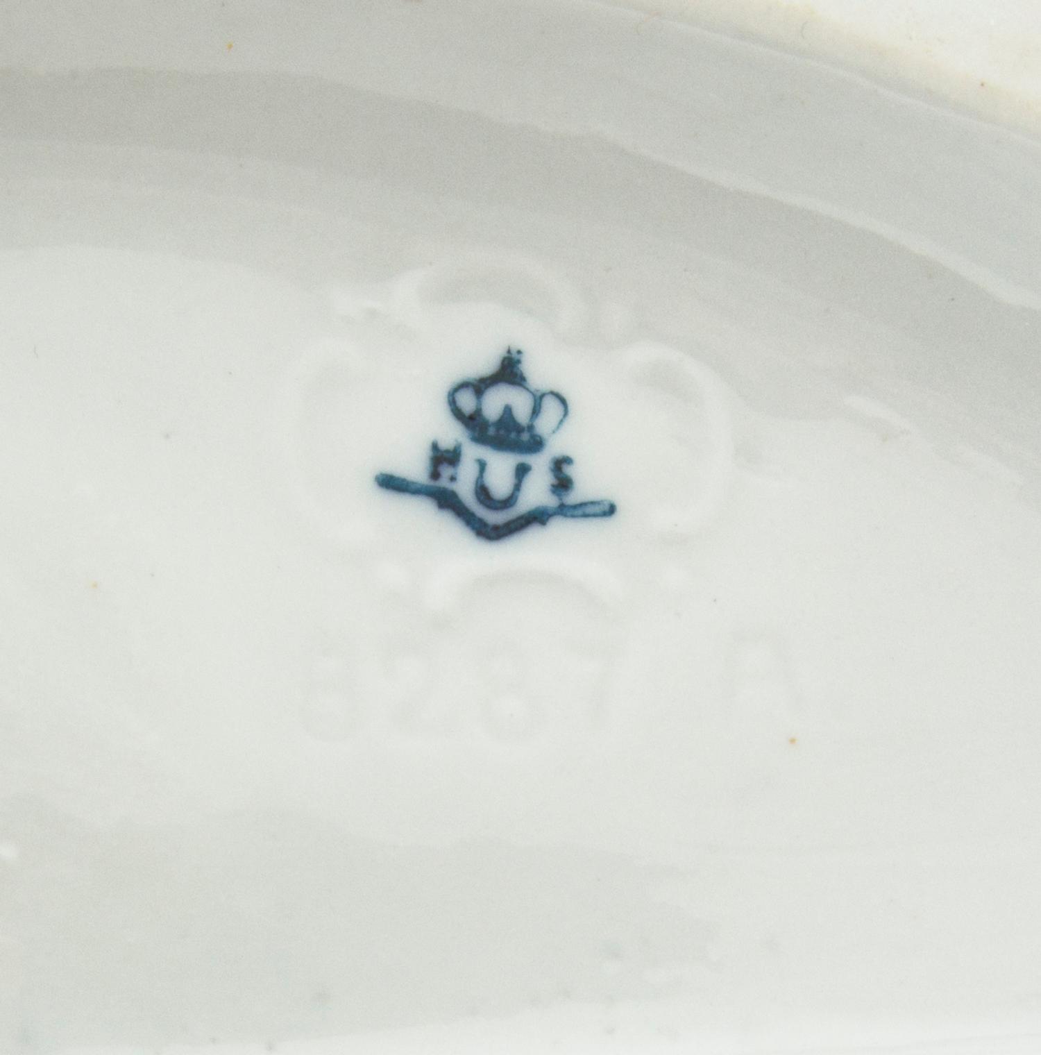 A Continental Porcelain Figural Group, Height 7 inches.