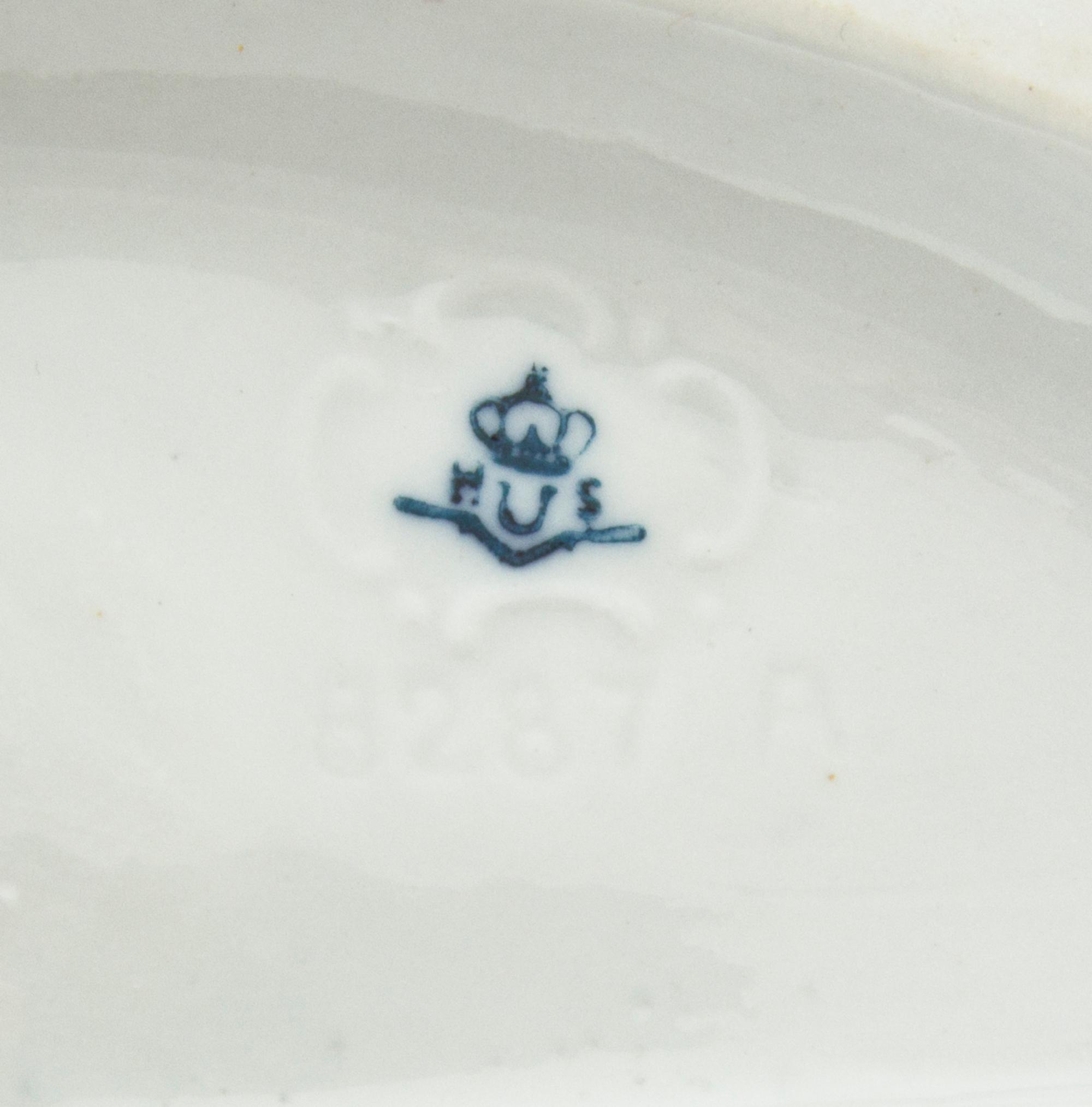 A Continental Porcelain Figural Group, Height 7 inches.