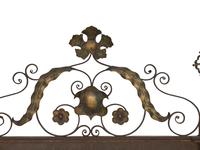 A Continental Patinated Iron and Gilt Tole Mirror