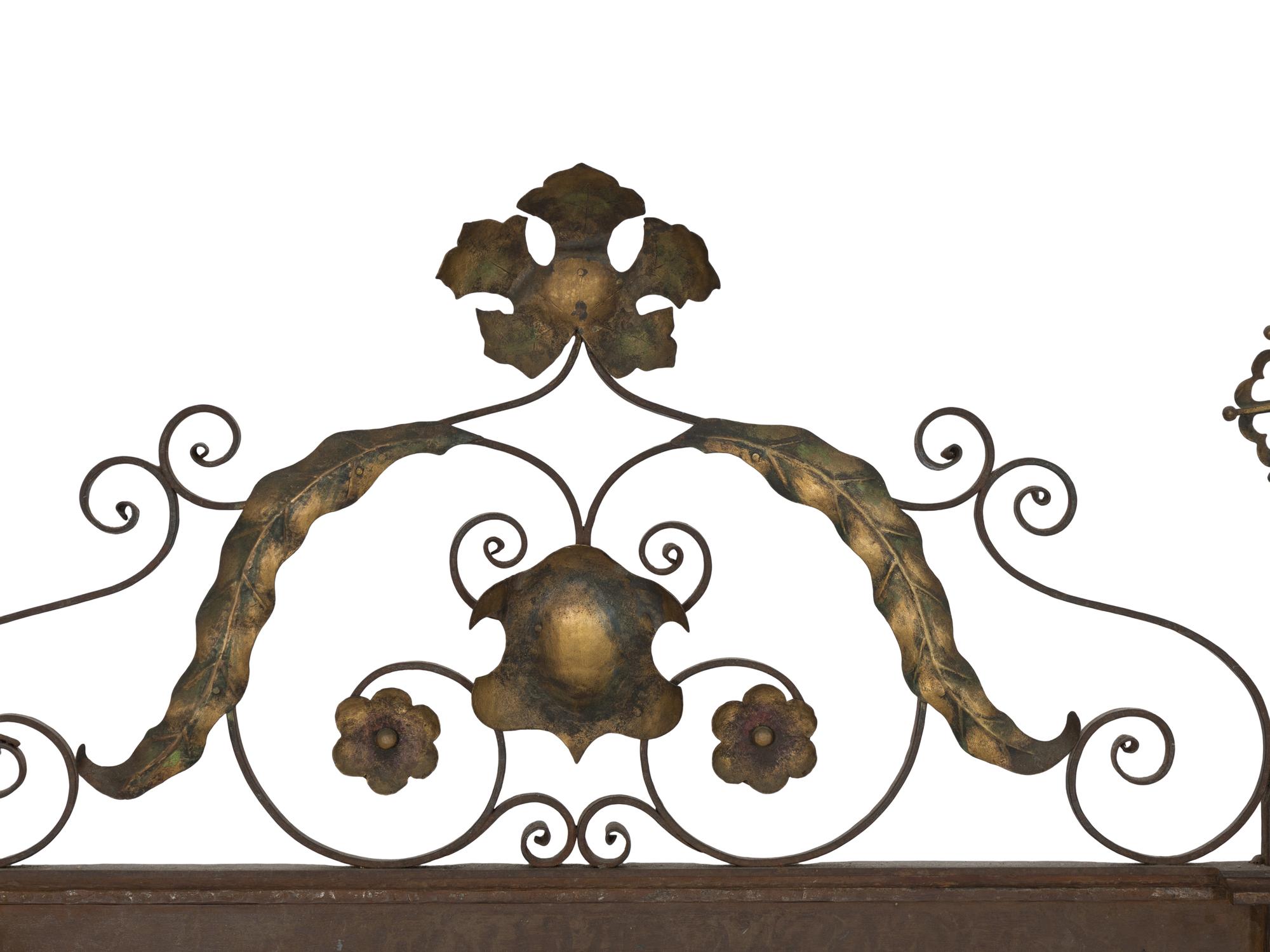 A Continental Patinated Iron and Gilt Tole Mirror