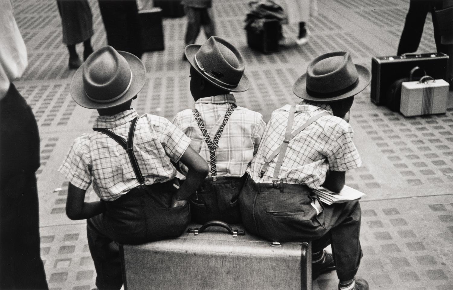 Ruth Orkin (1921-1985) Three Boys on a Suitcase, Penn Station, New York City, 1947
