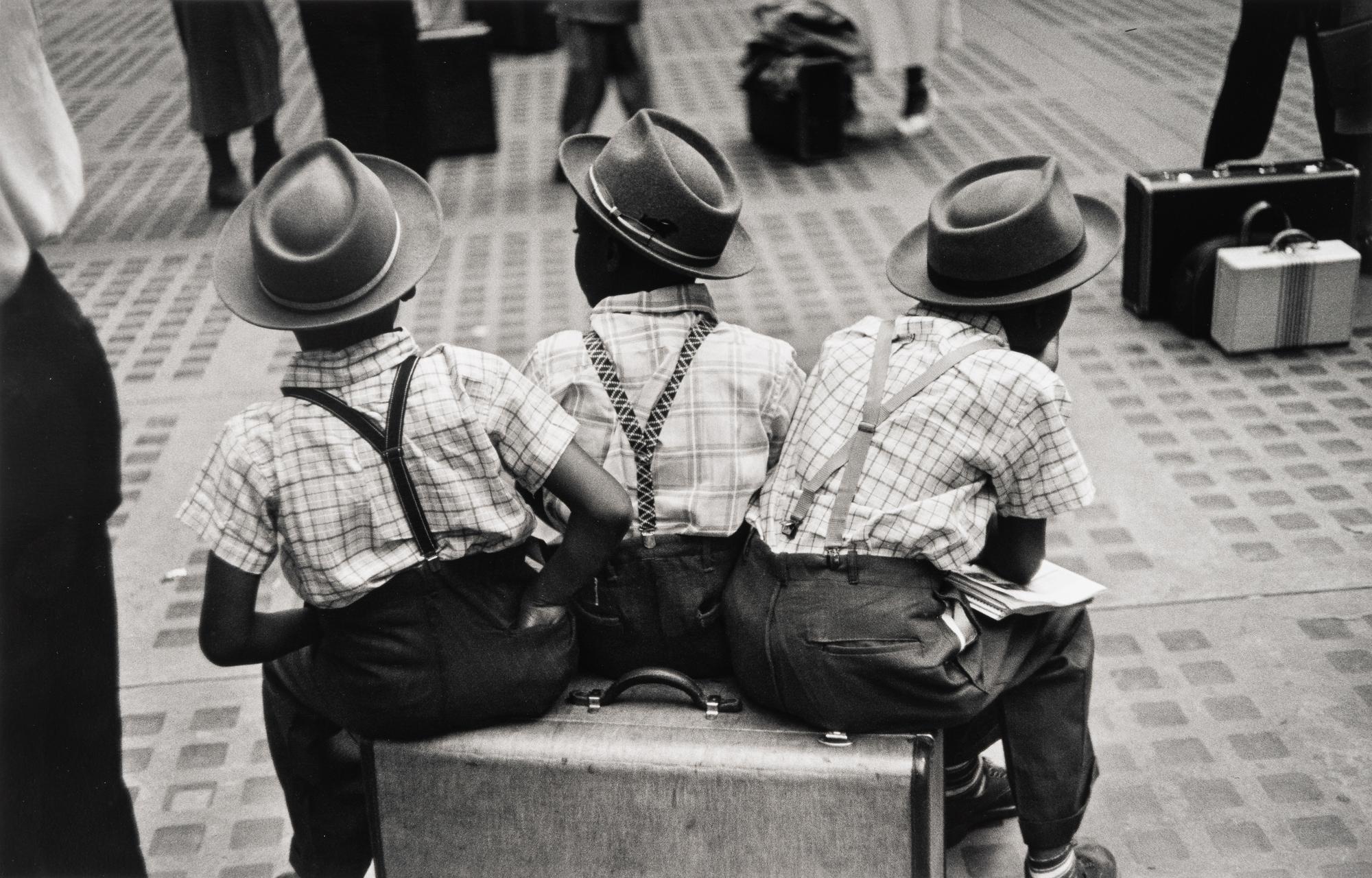 Ruth Orkin (1921-1985) Three Boys on a Suitcase, Penn Station, New York City, 1947